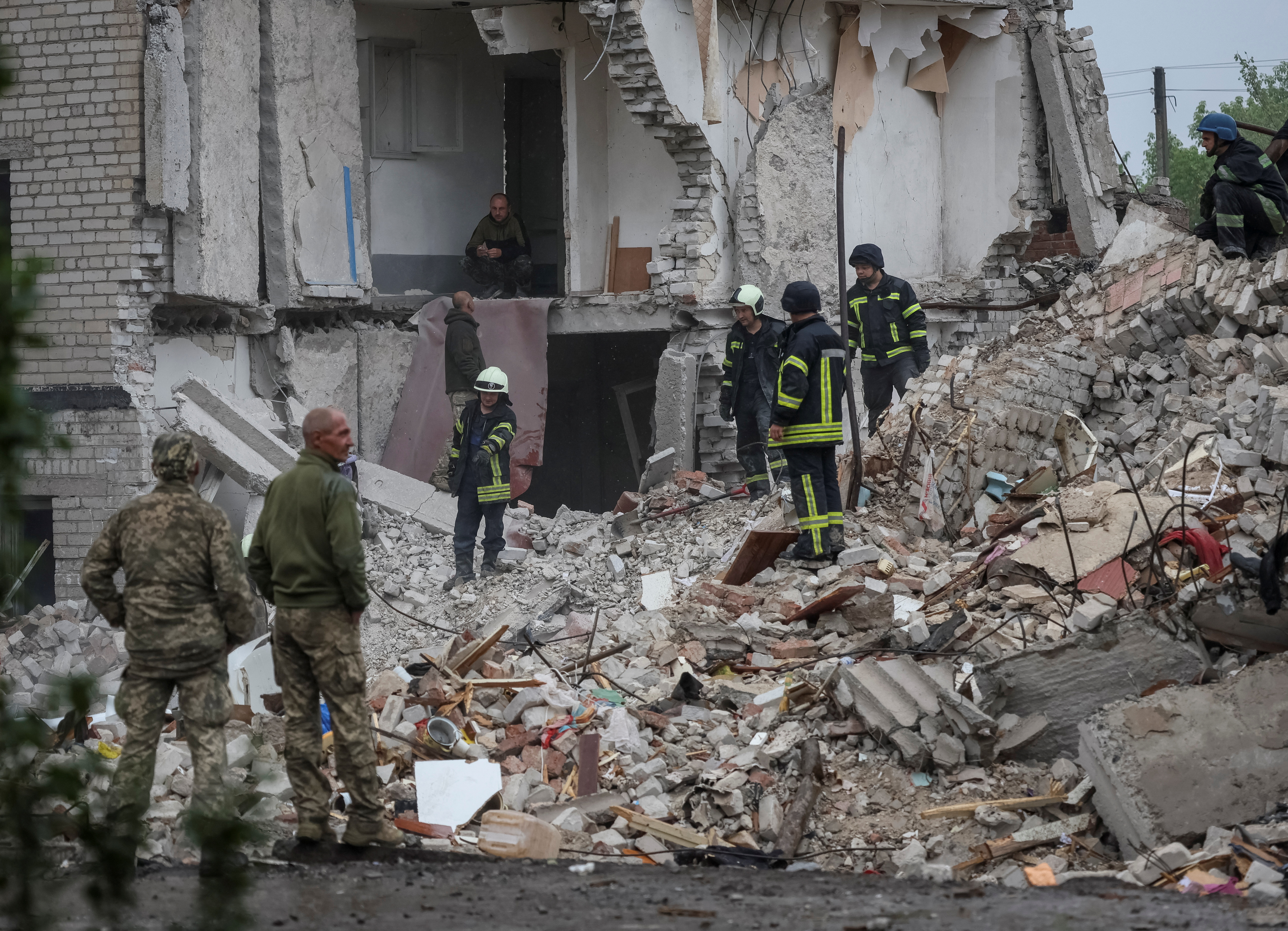 Rescuers work at a residential building damaged by a Russian military strike in the town of Chasiv Yar, in Donetsk region, Ukraine, July 11, 2022 