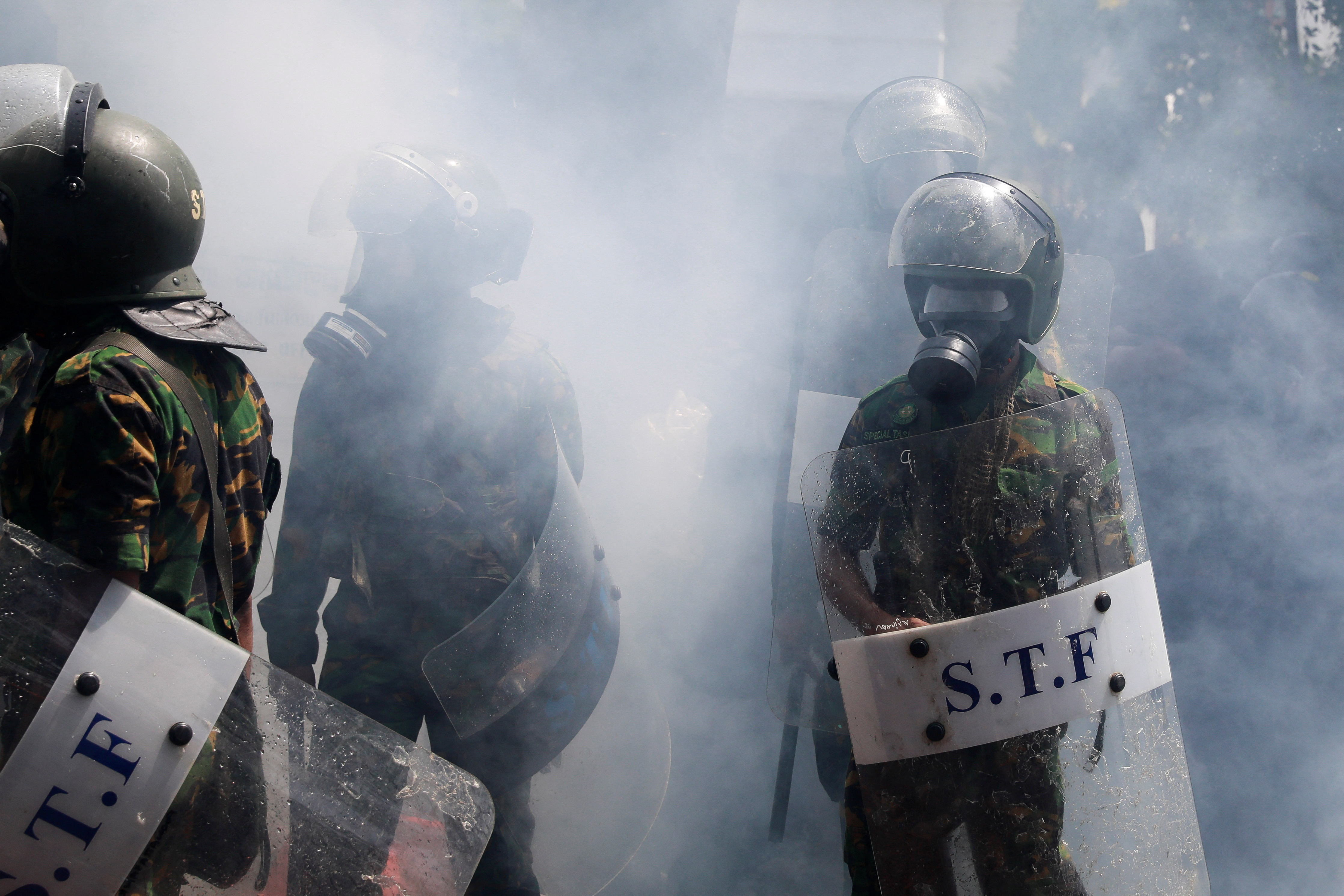 Members of the police stand guard during a protest outside the office of Sri Lanka's Prime Minister