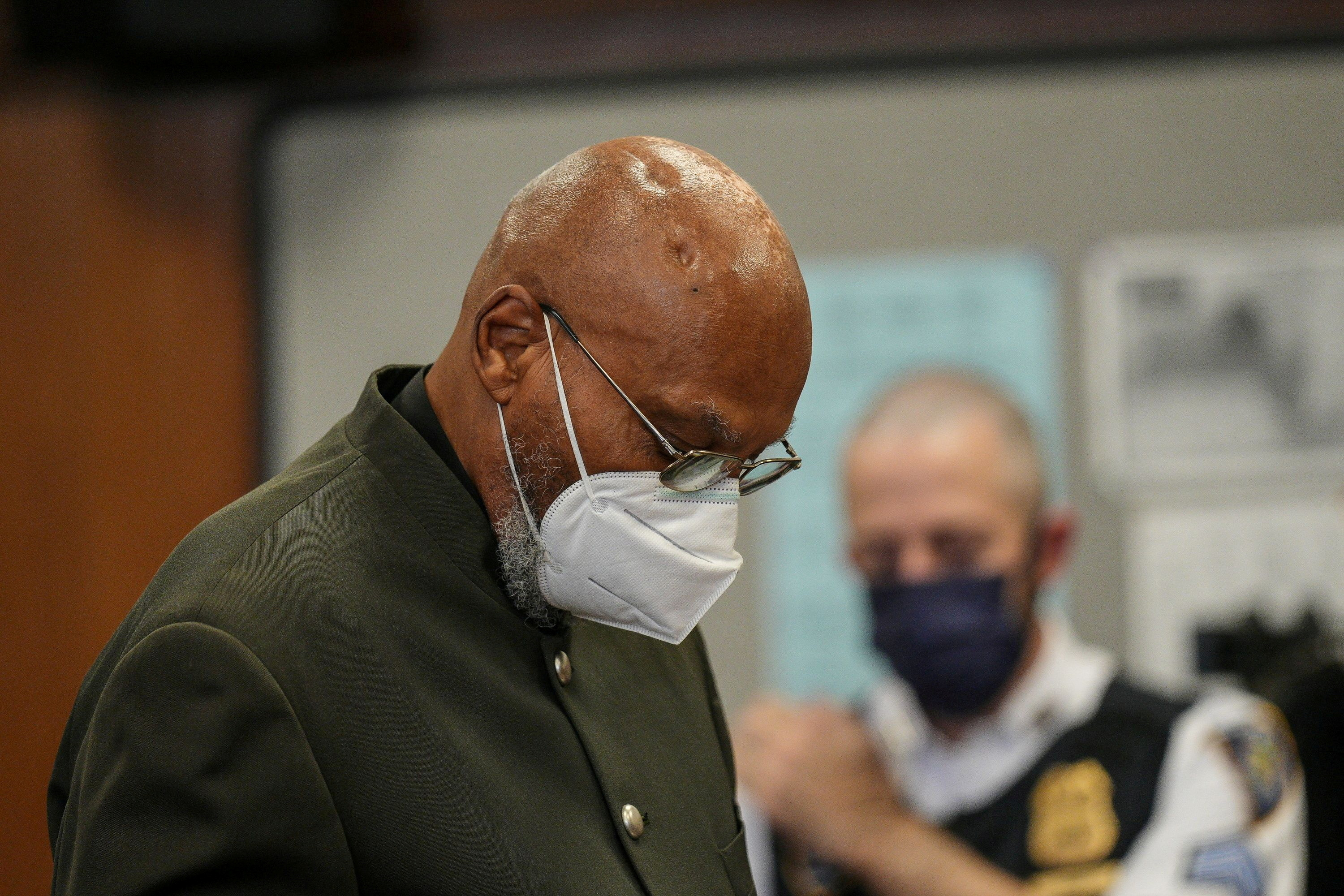 Muhammad Aziz in court wearing a mask.