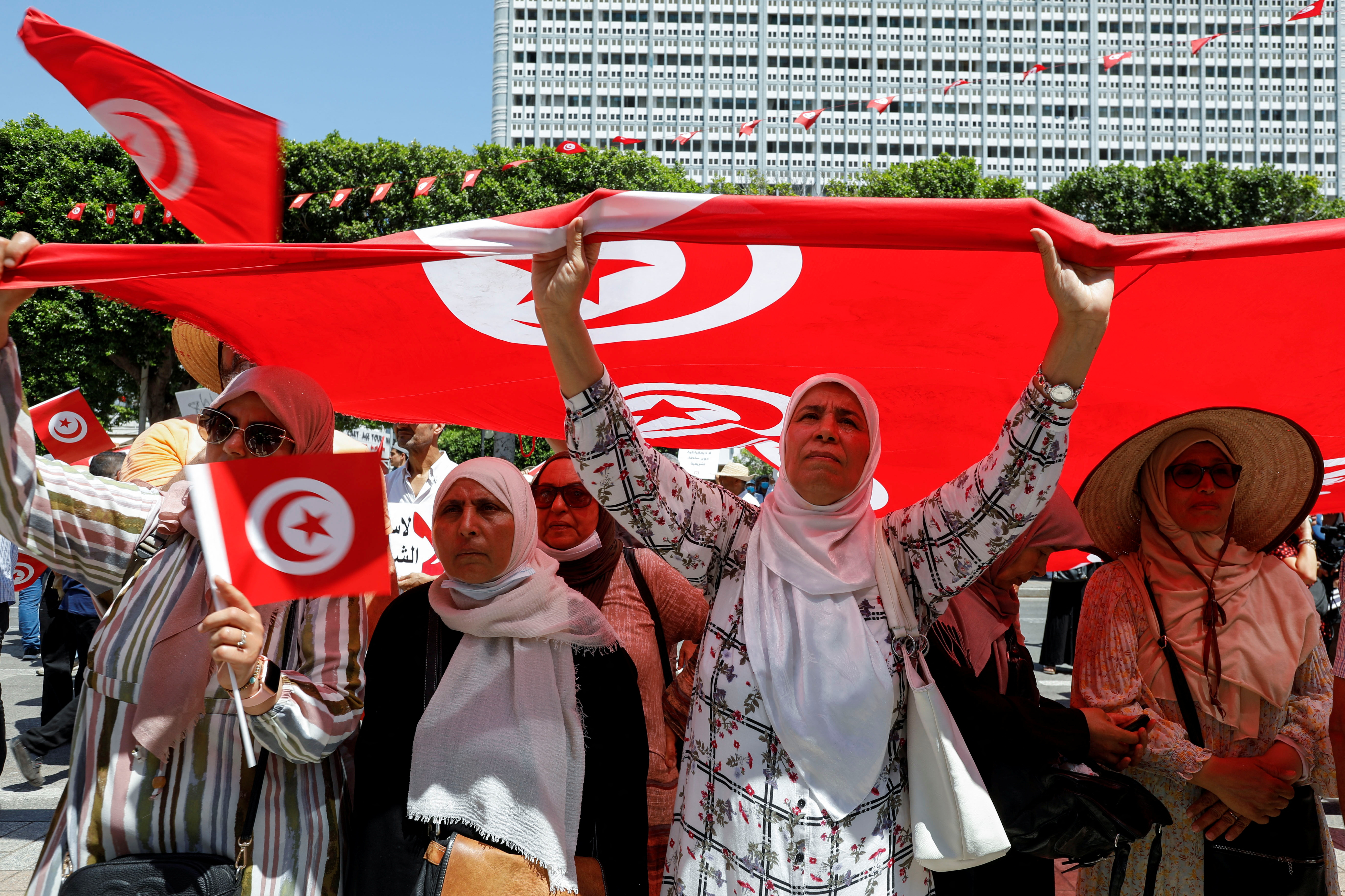 protesters hold tunisian flag