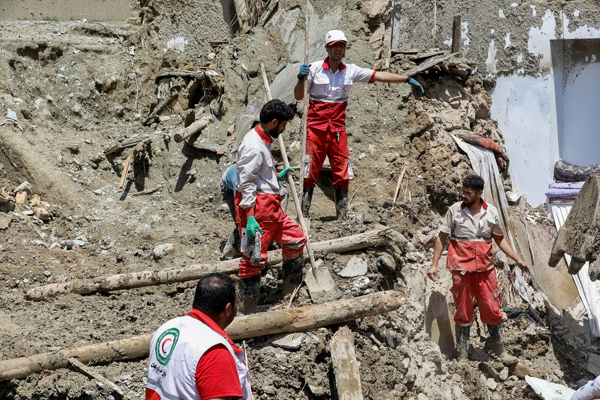 Rescuers work following the flood in Firuzkuh, east of Tehran