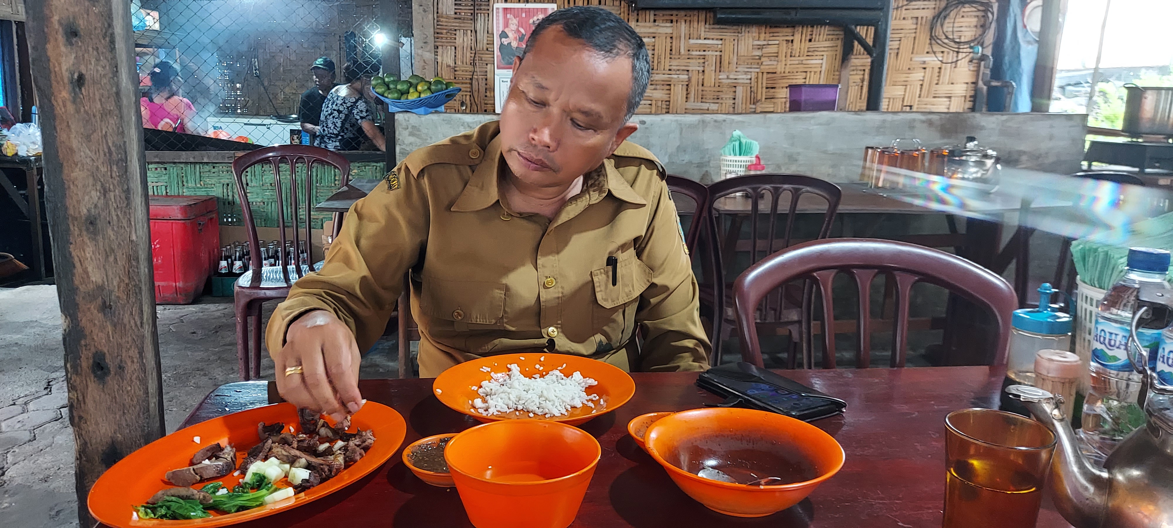 Silas Sihombing sitting in a dog restaurant.
