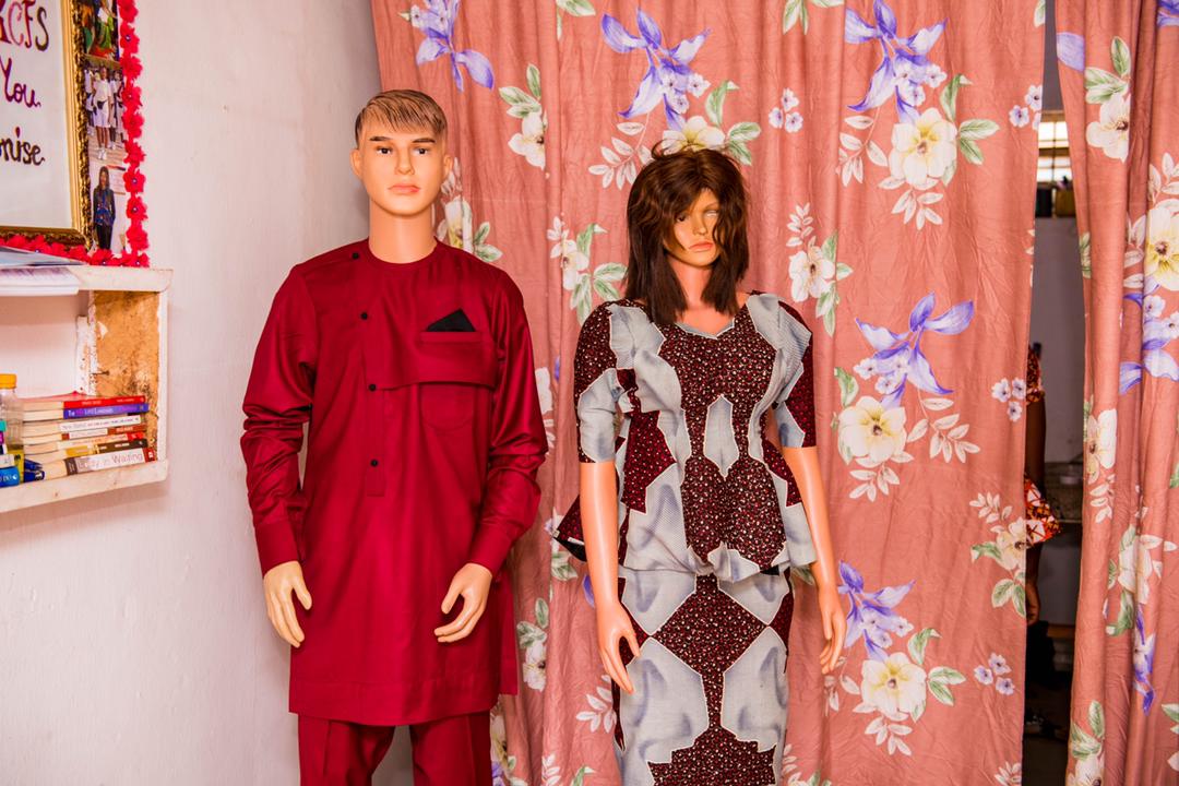 A seamstress places two of her items on display. In a report published in 2019, UN Women recommended investing in capacity-building programs (including training in marketing and sales) for women entrepreneurs to effectively compete in regional markets. Many of the women interviewed in Minna discussed the challenge of being undervalued because of their limited formal training. “The people that we are dealing with…someone [like me] is finding it difficult to please them the way they want,” one business owner shared. “They will see [my dresses] and would love it quite alright. But they will look down on [me and my products] and what they are supposed to spend on it, they will not like to spend on it.”