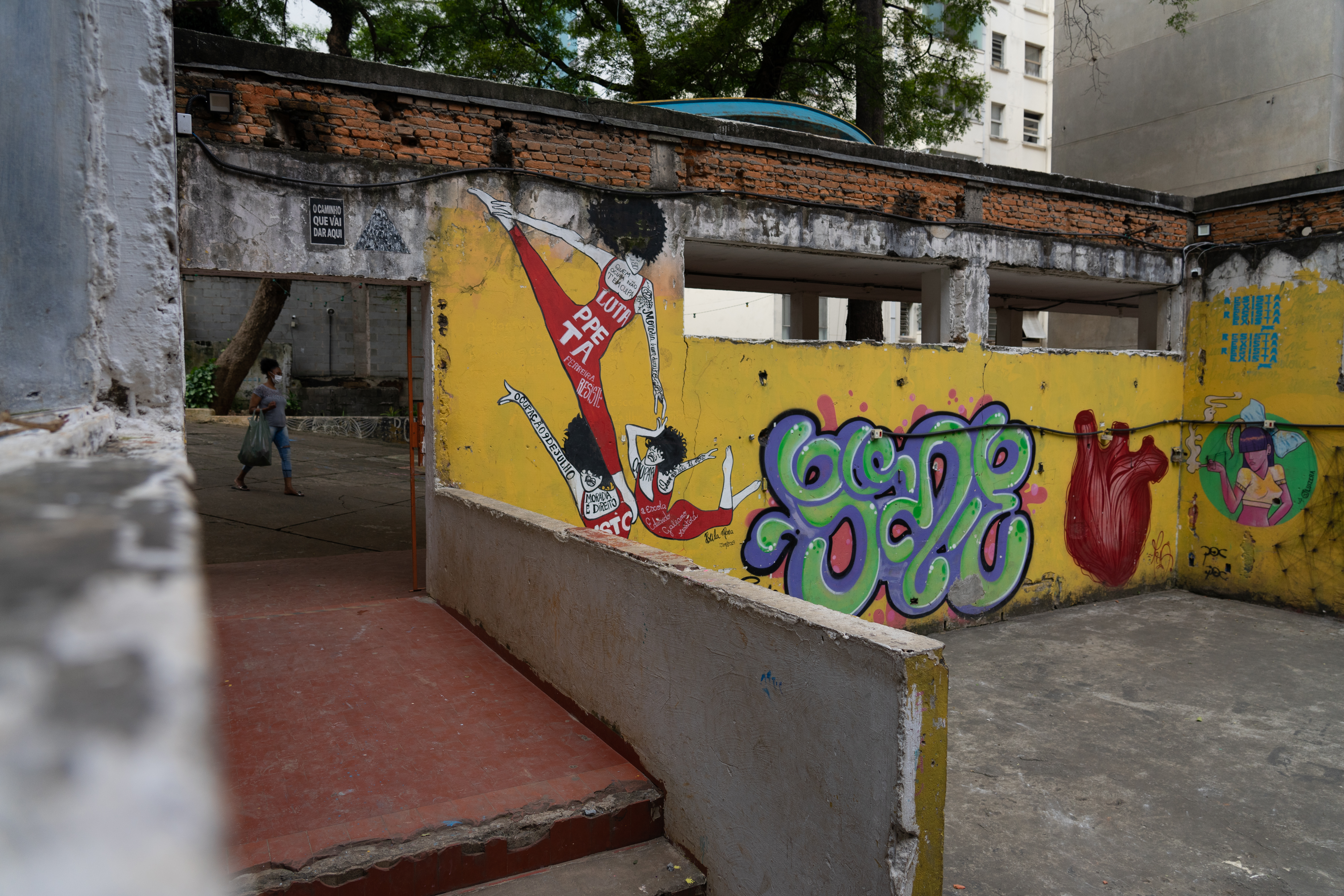 Woman walks past the 9 de Julho courtyard