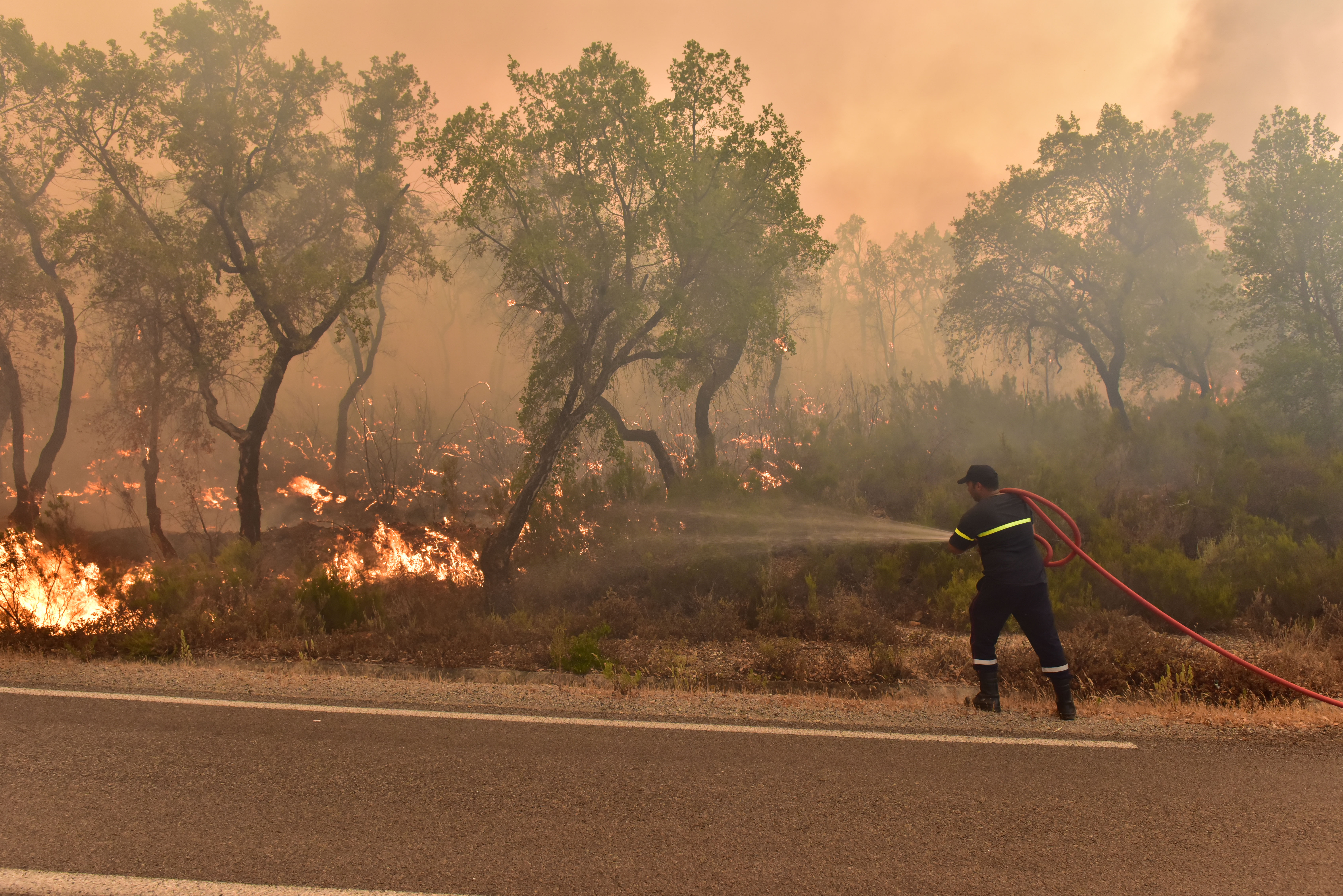 Firefighters intervene by land to control a wildfire in Rabat