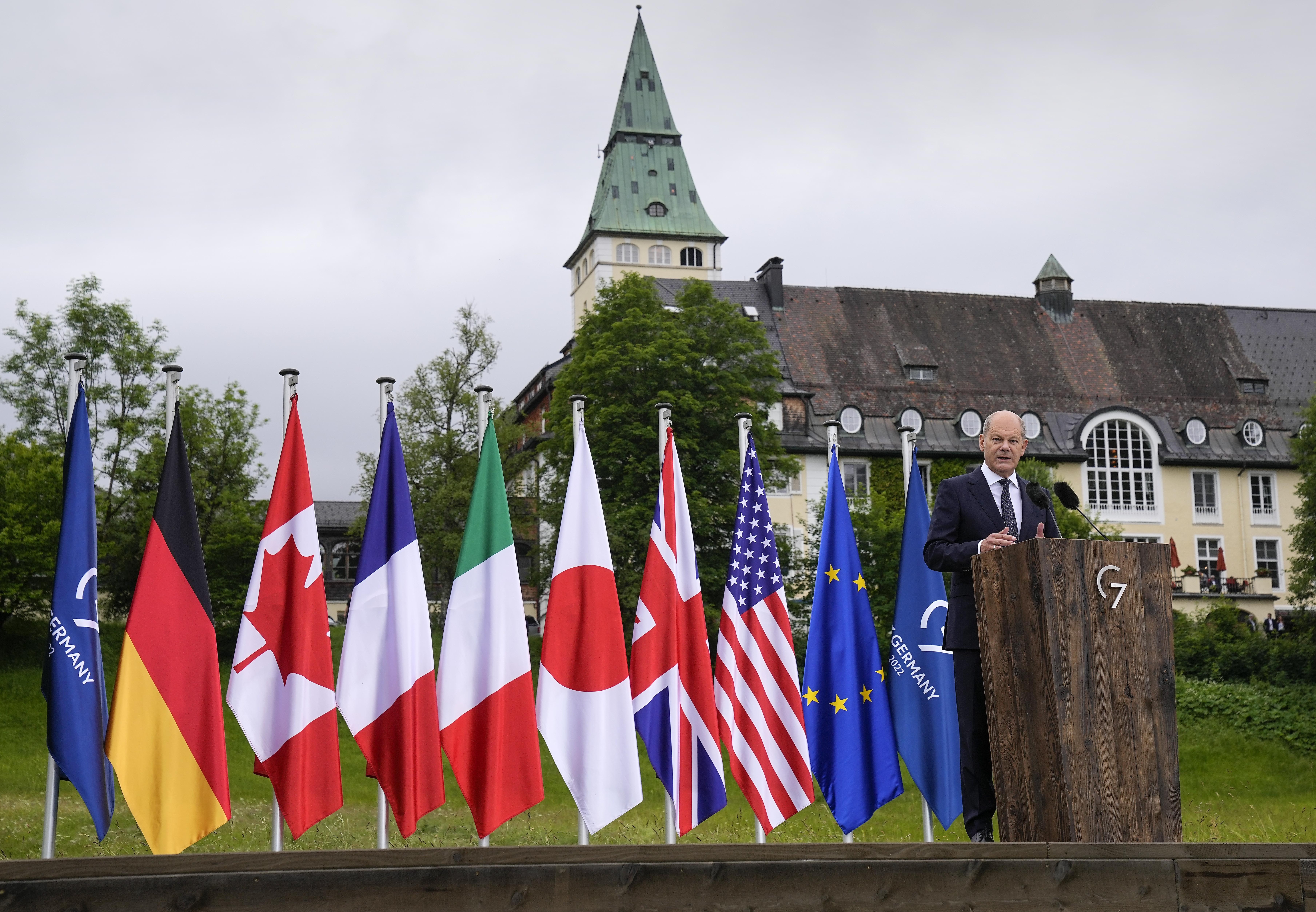 German chancellor with flags of the G7