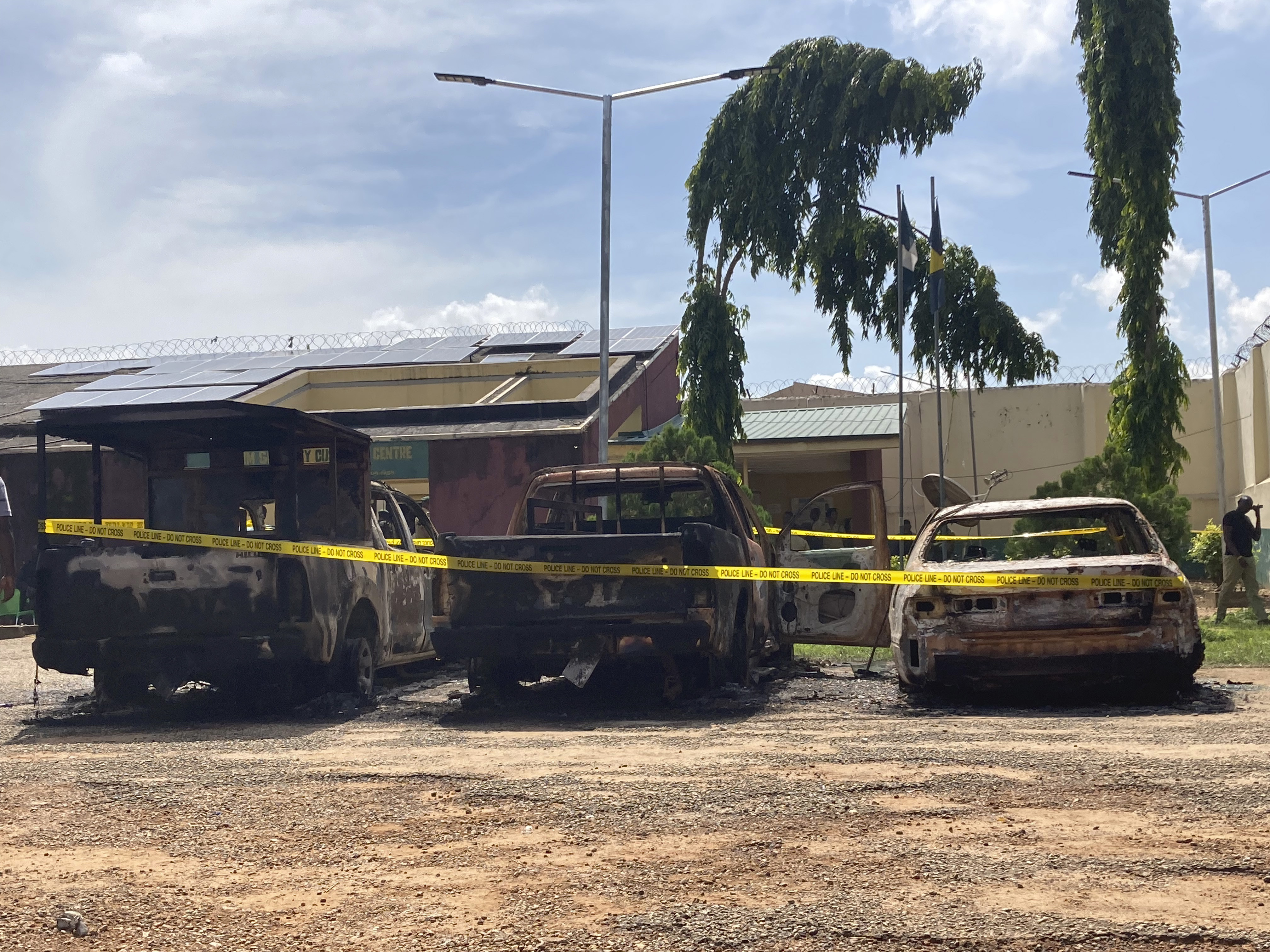 Charred cars are seen outside the Kuje maximum prison