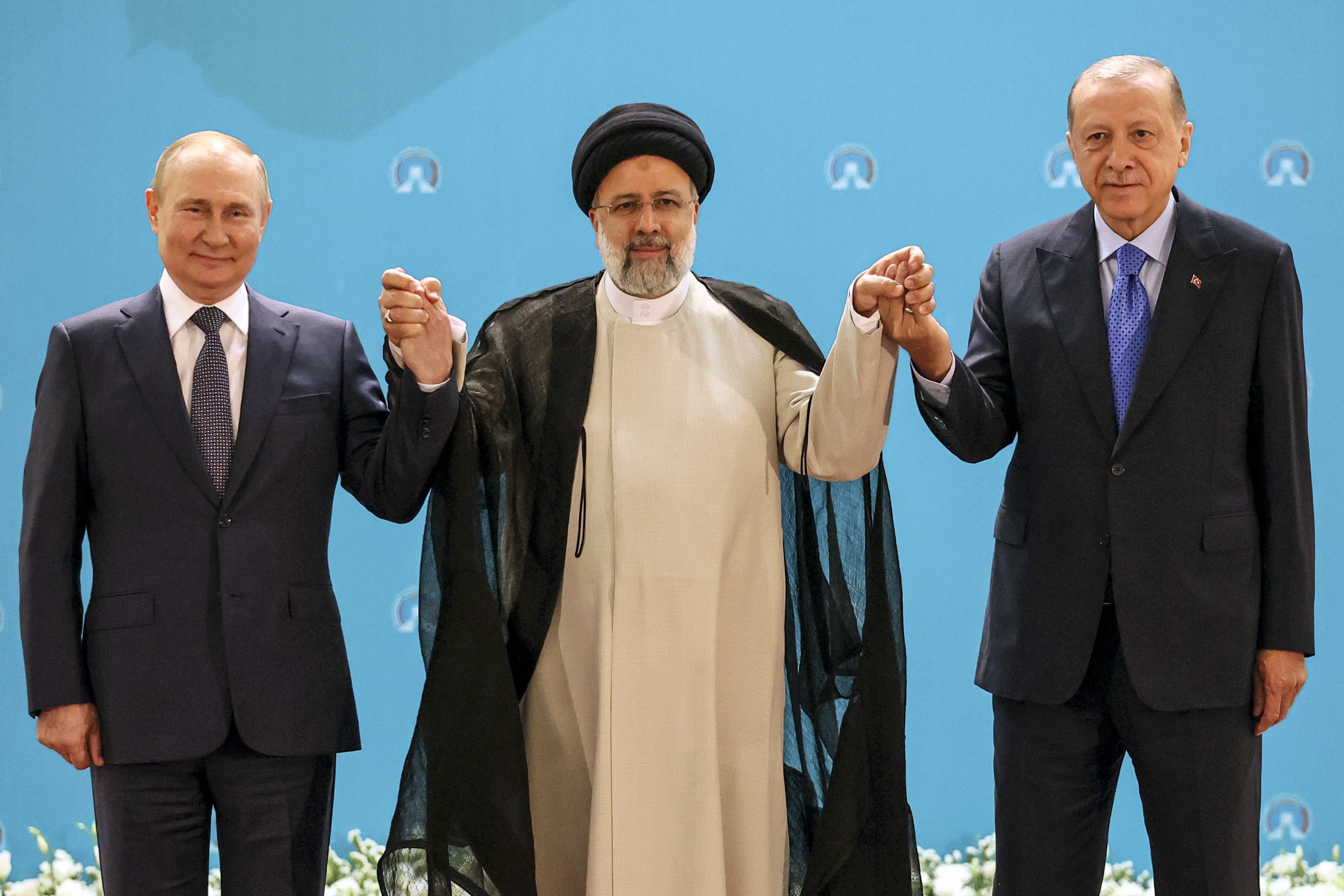 Russian President Vladimir Putin, Iranian President Ebrahim Raisi and Turkish President Recep Tayyip Erdogan pose for a photo in Tehran, Iran