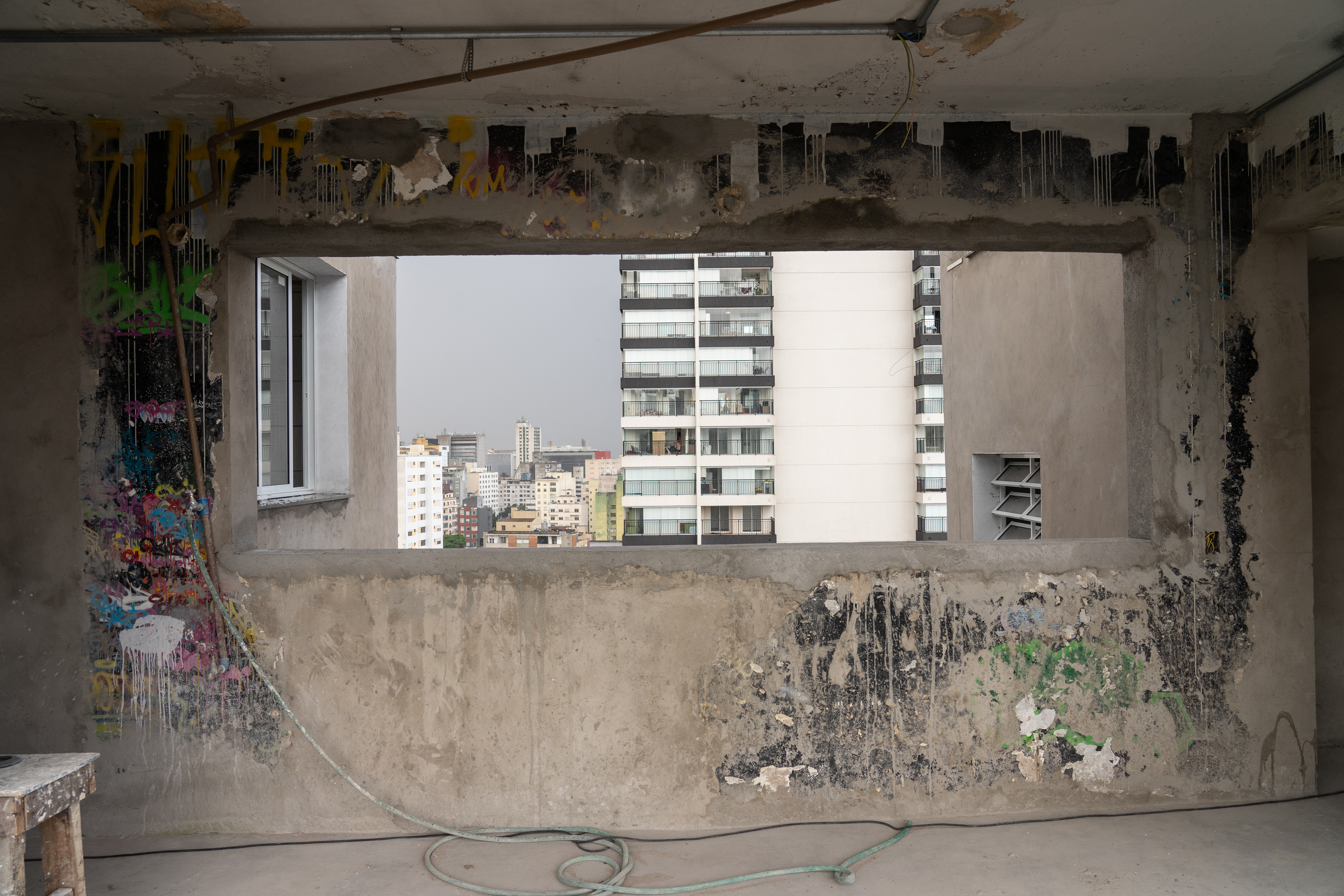 Remnants of graffiti painted during the occupation are seen against the backdrop of the city