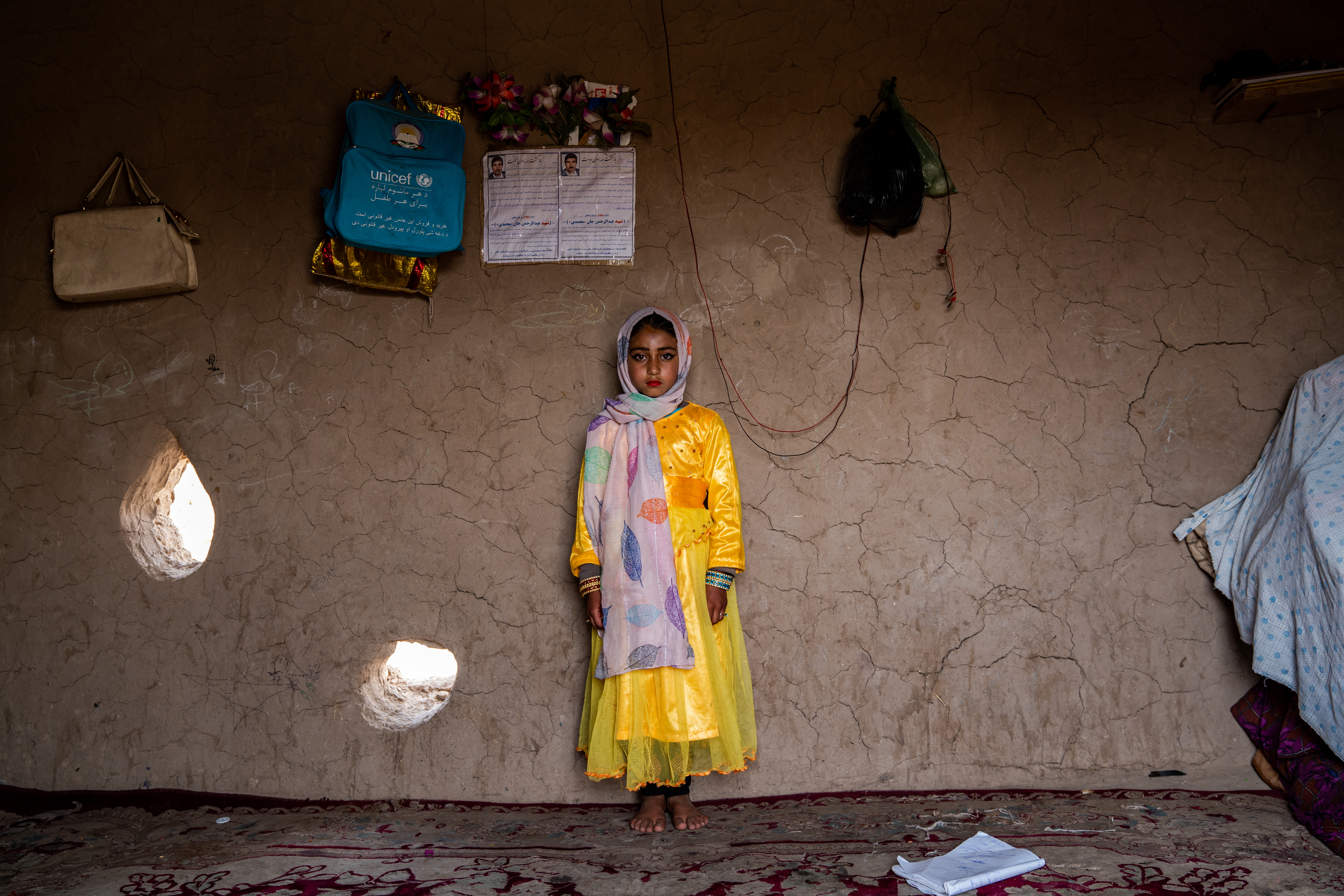 A young Afghan girl dressed in a yellow dress for her engagement to be married