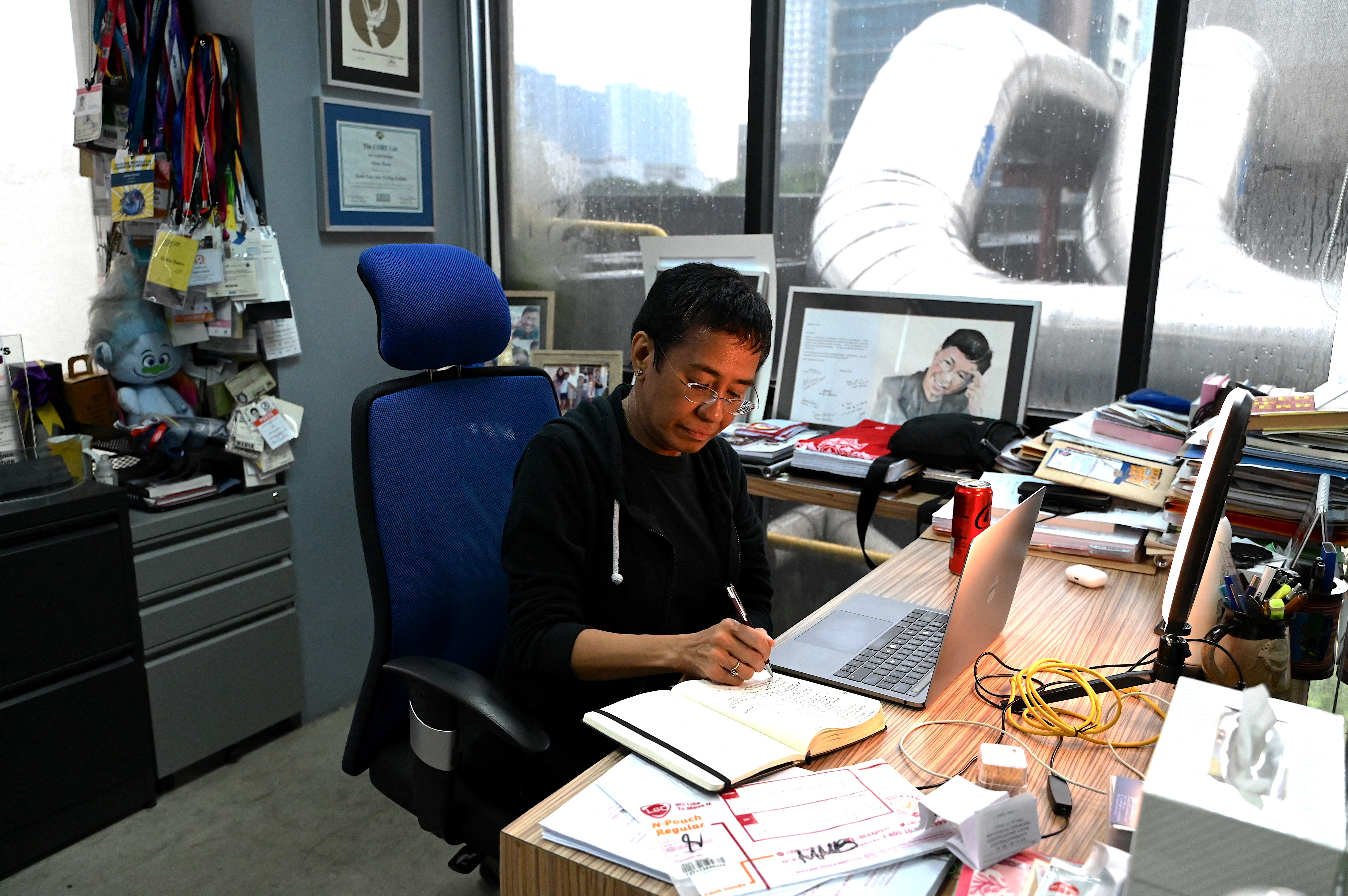 Rappler founder and journalist Maria Ressa working at her desk in the Rappler office in Manila