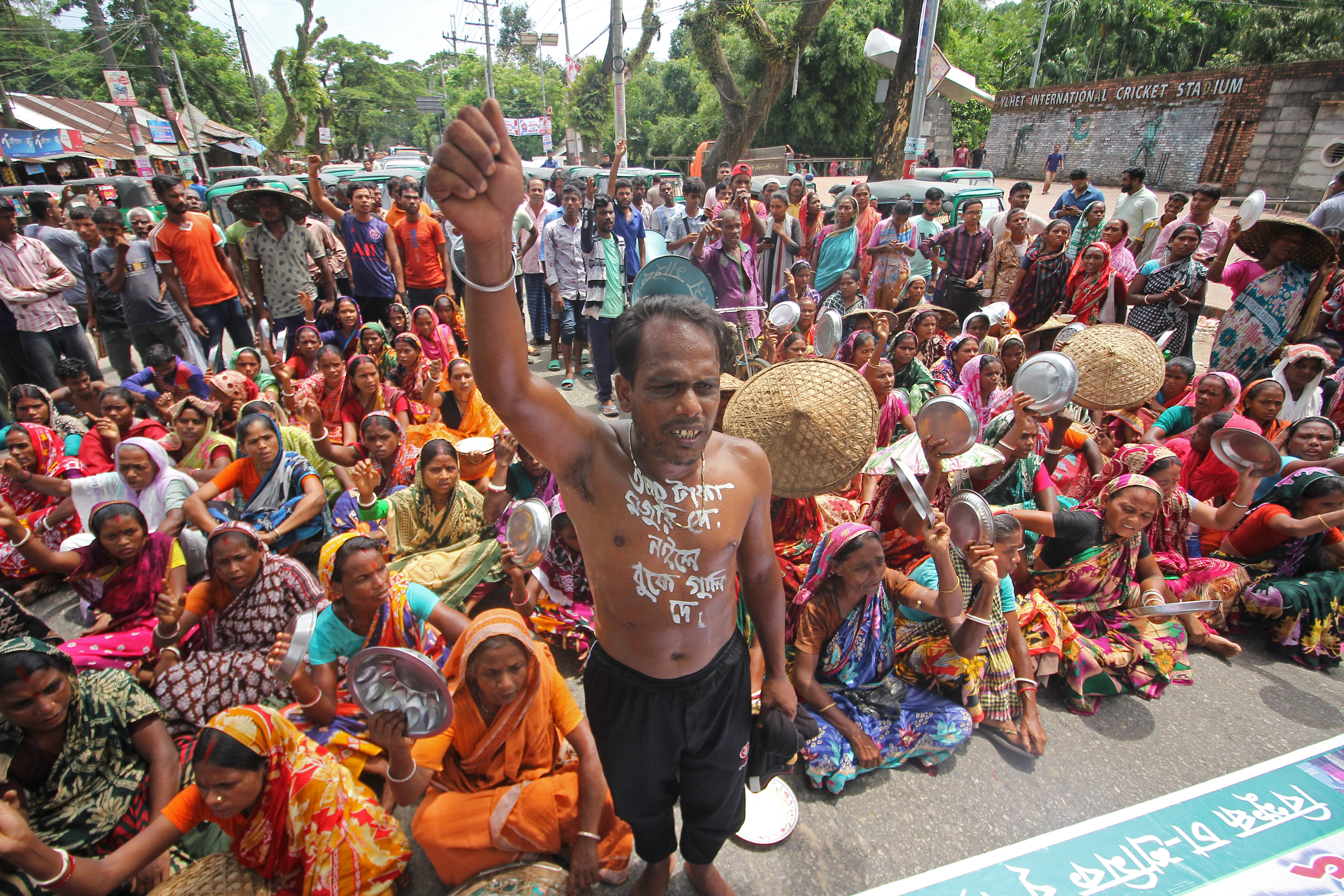 Tea garden workers gather to take part in a protest demanding hike in their daily wages.