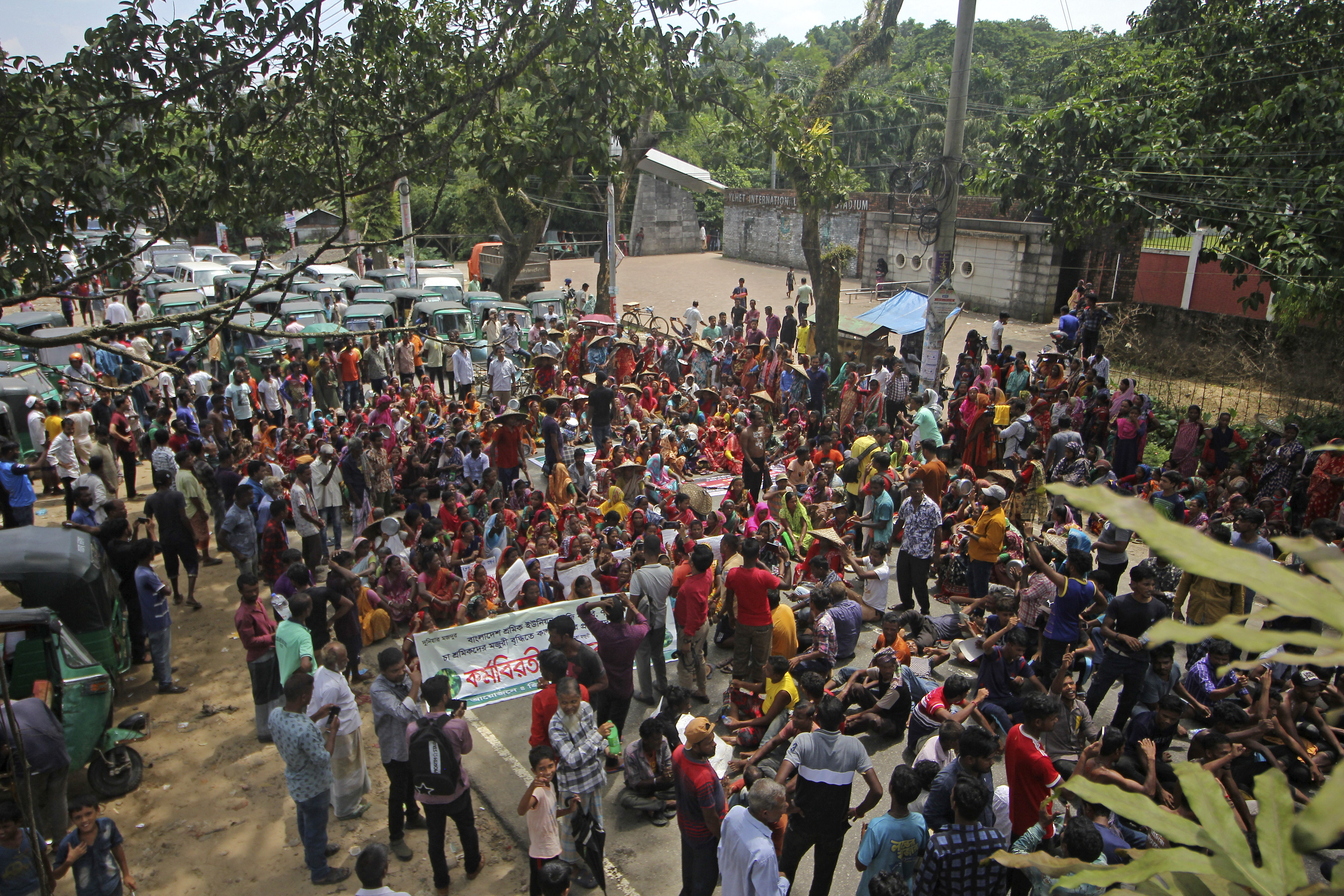 Tea garden workers gather to take part in a protest demanding hike in their daily wages.