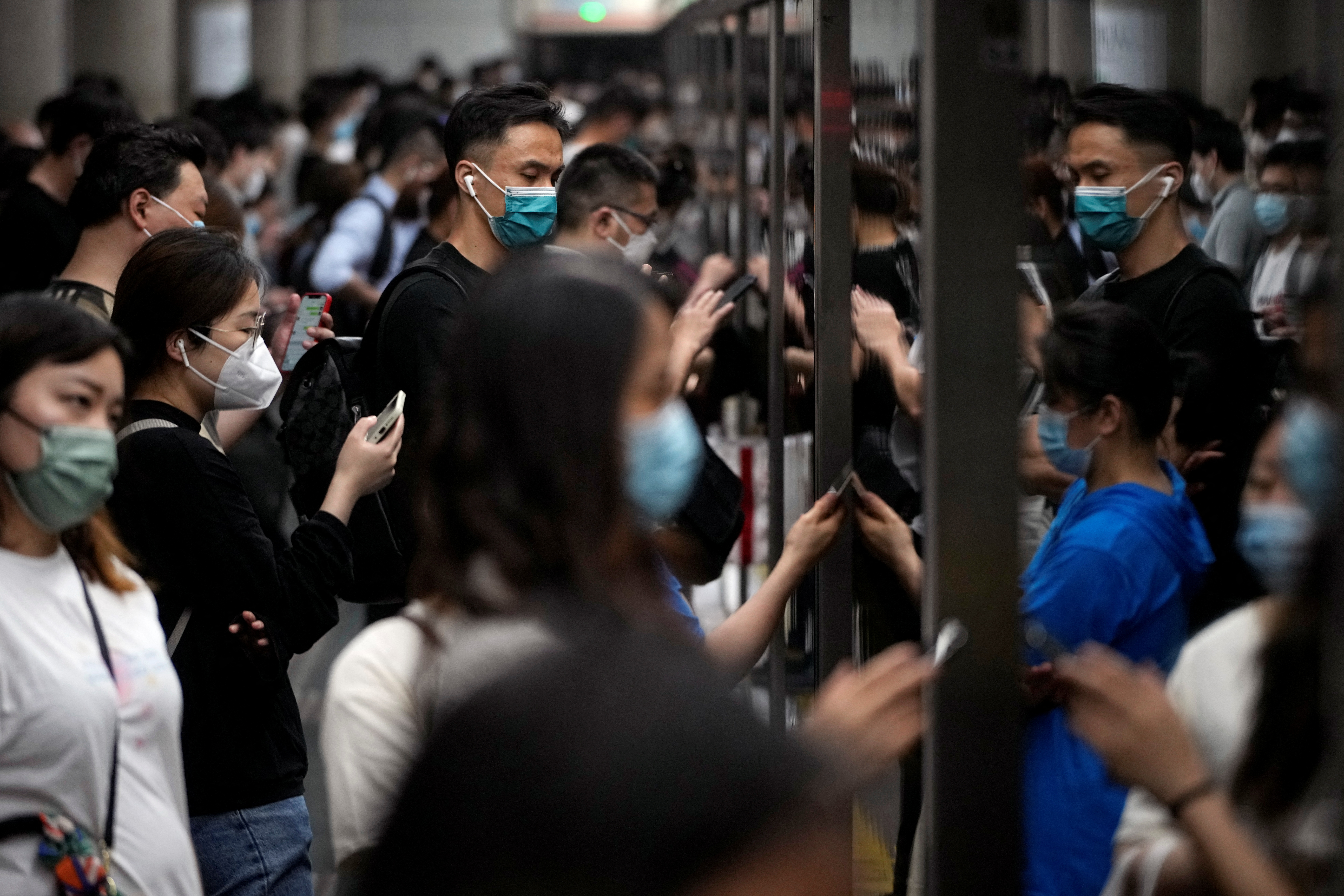 Commuters crowd on the station platform during rush hour in Shanghai
