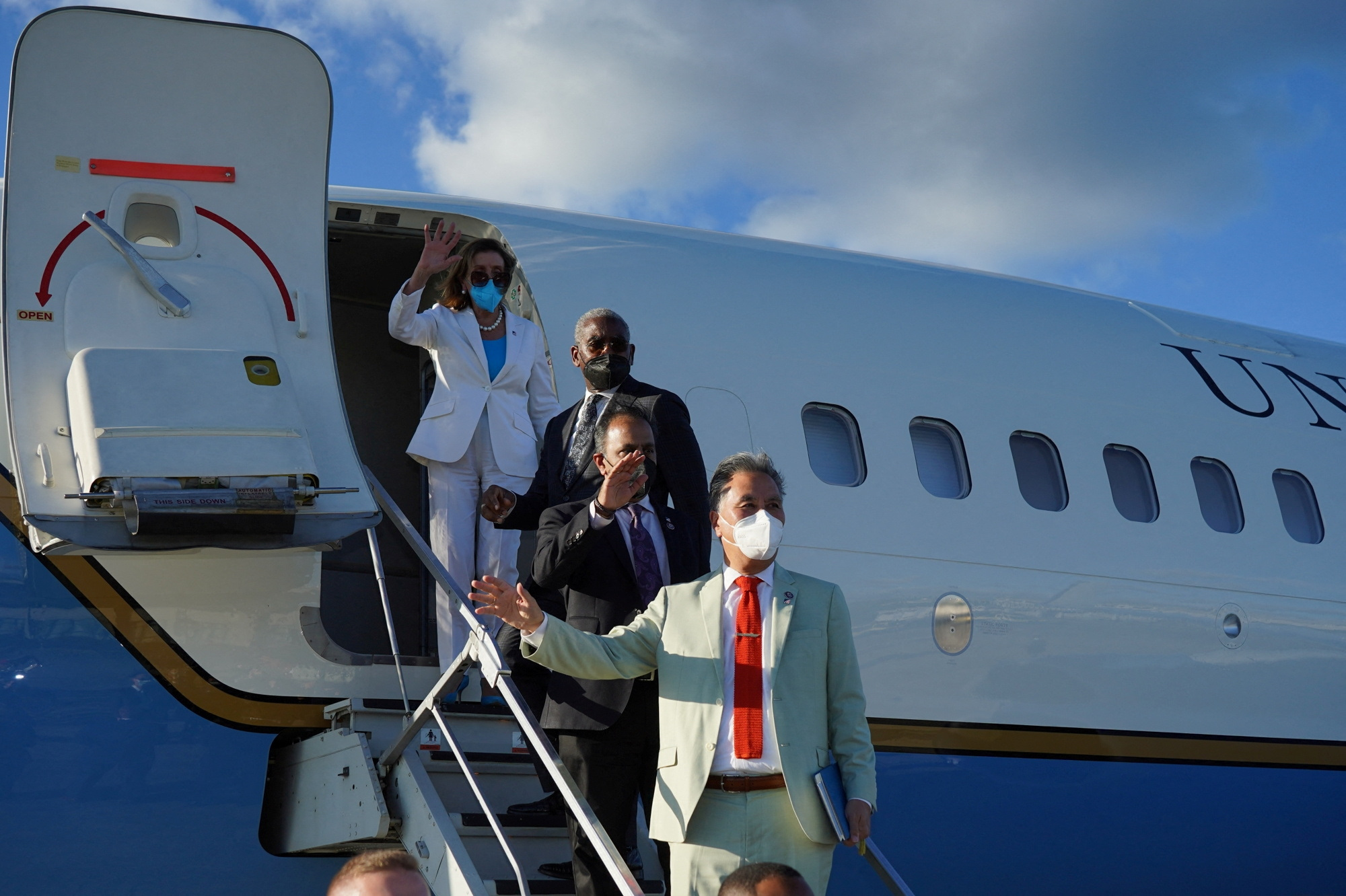 US House of Representatives Speaker Nancy Pelosi and members of her delegation wave as they board a plane in Taipei, Taiwan.
