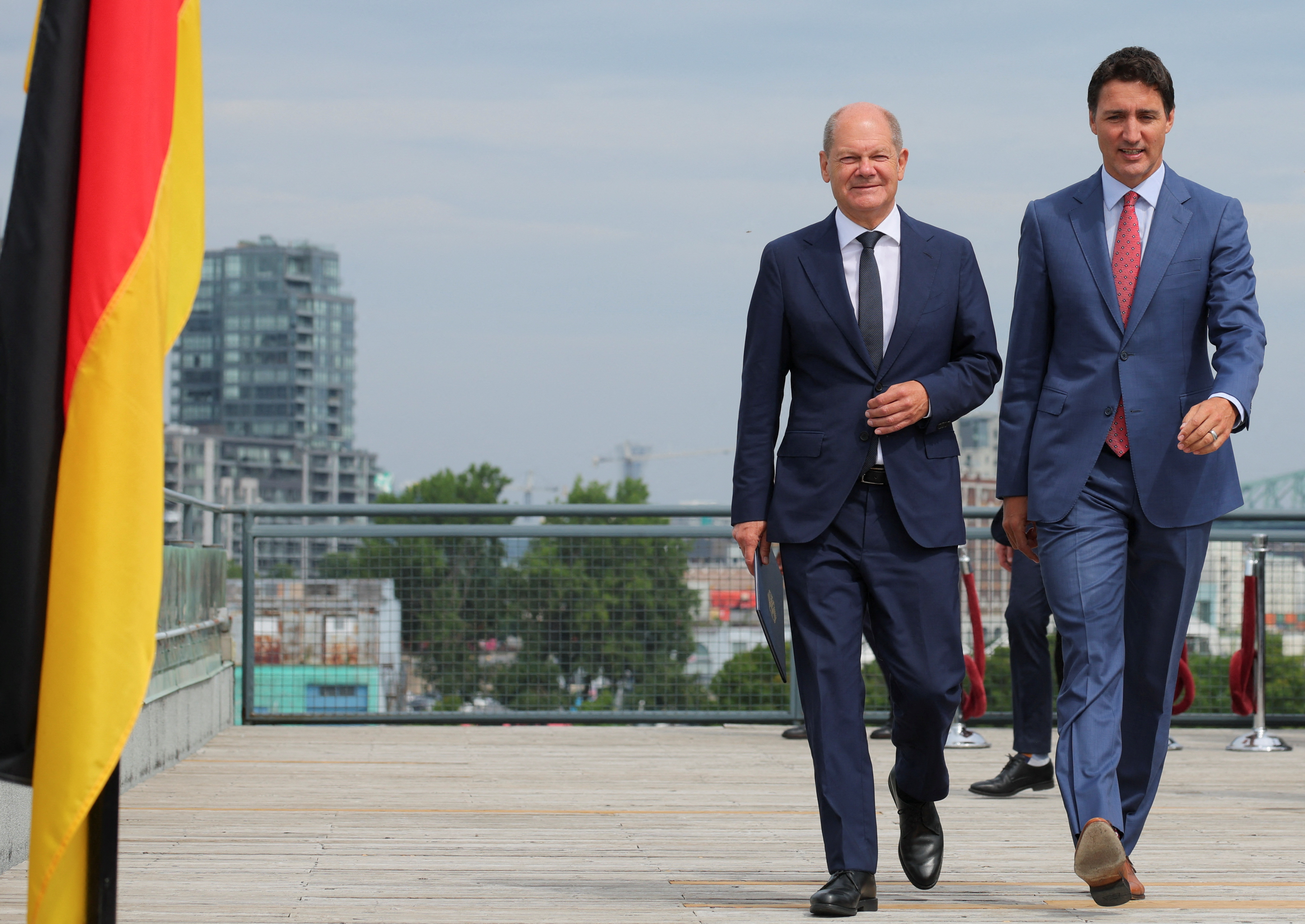 German Chancellor Olaf Scholz walks alongside Canadian Prime Minister Justin Trudeau