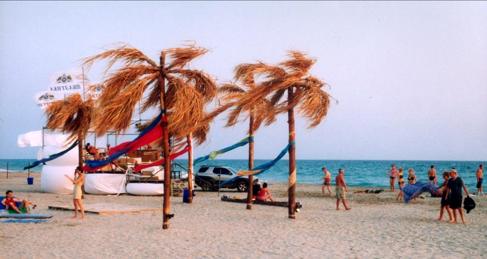 A photo of a beach with people sunbathing and walking around during the KaZantip festival.