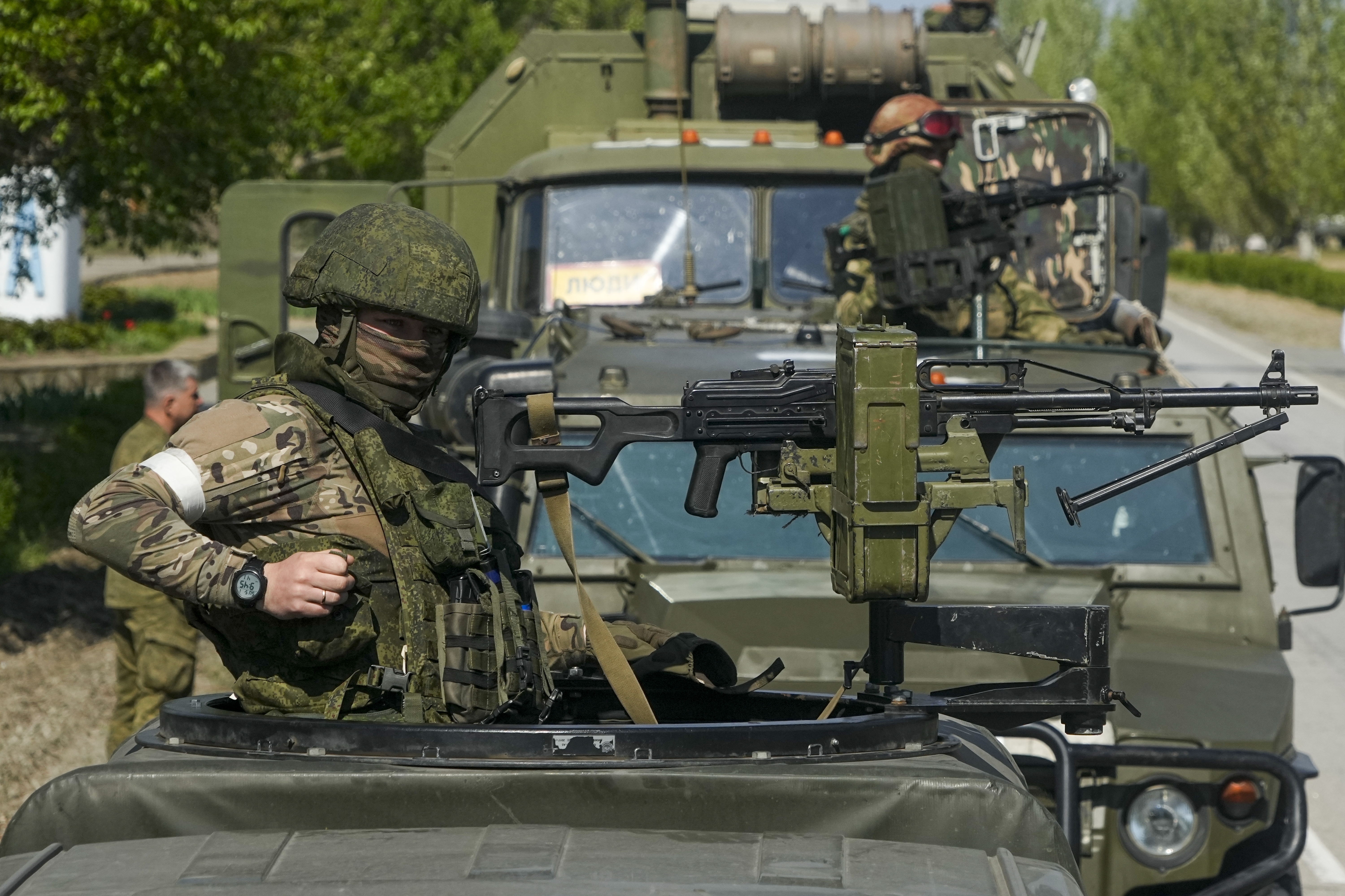 Armed Russian servicemen stand atop their military vehicles near the Zaporizhzhia Nuclear Power Station, the largest nuclear power plant in Europe and among the 10 largest in the world, in Enerhodar, Zaporizhzhia region, in territory under Russian military control, southeastern Ukraine