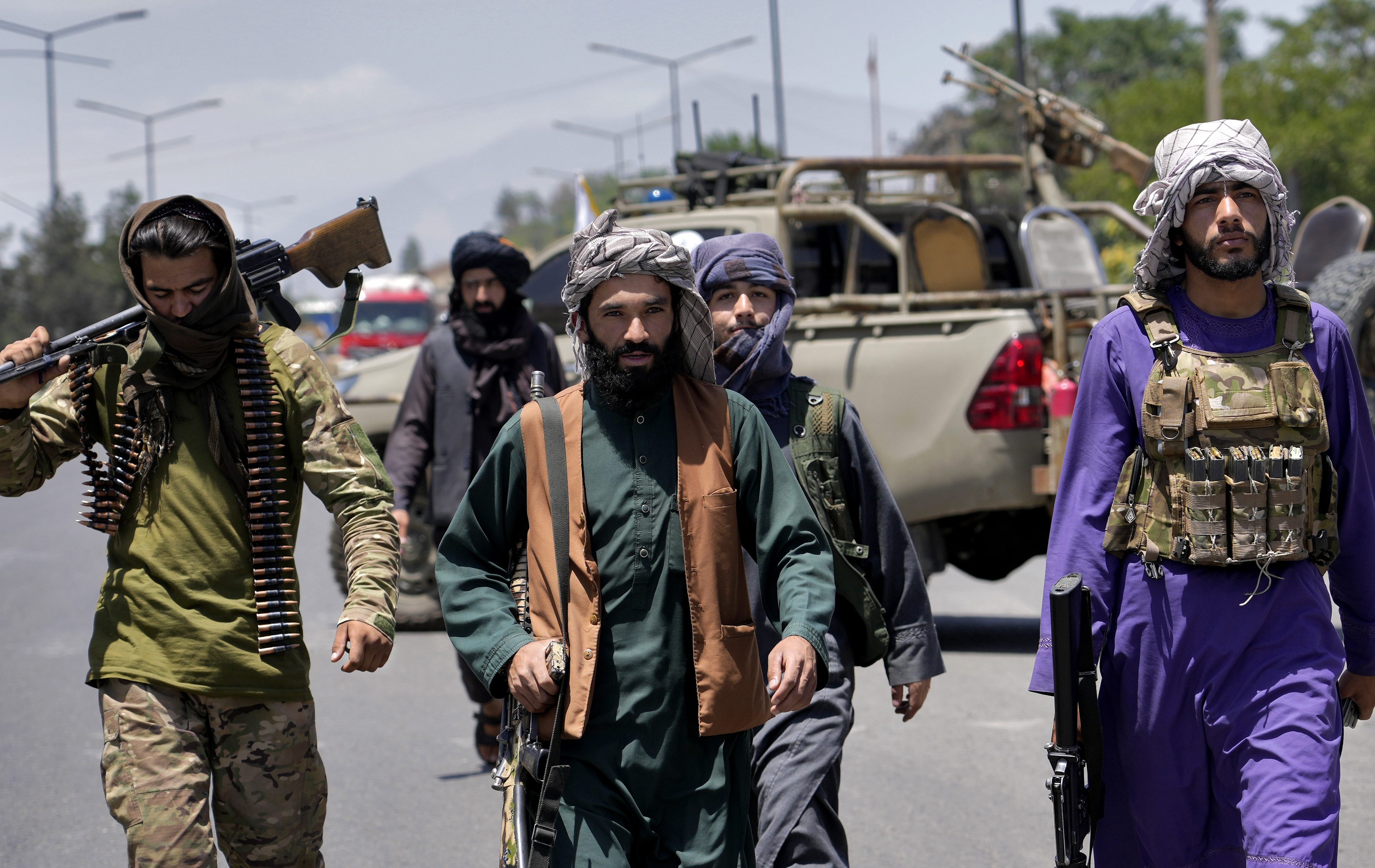 Taliban fighters guard at the site of an explosion in Kabul.