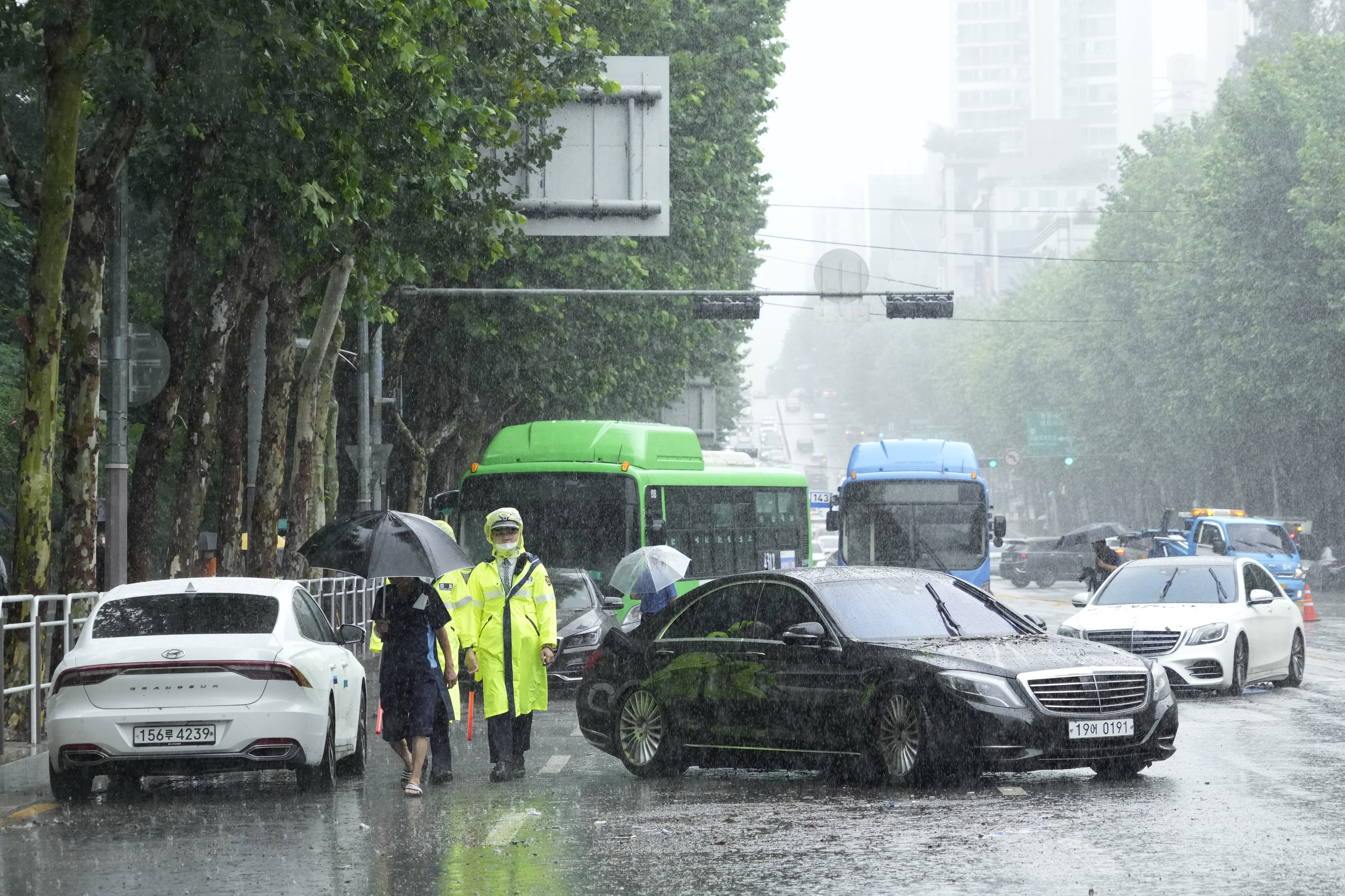 Vehicles, which had been submerged by the heavy rainfall, block a road in Seoul, South Korea.