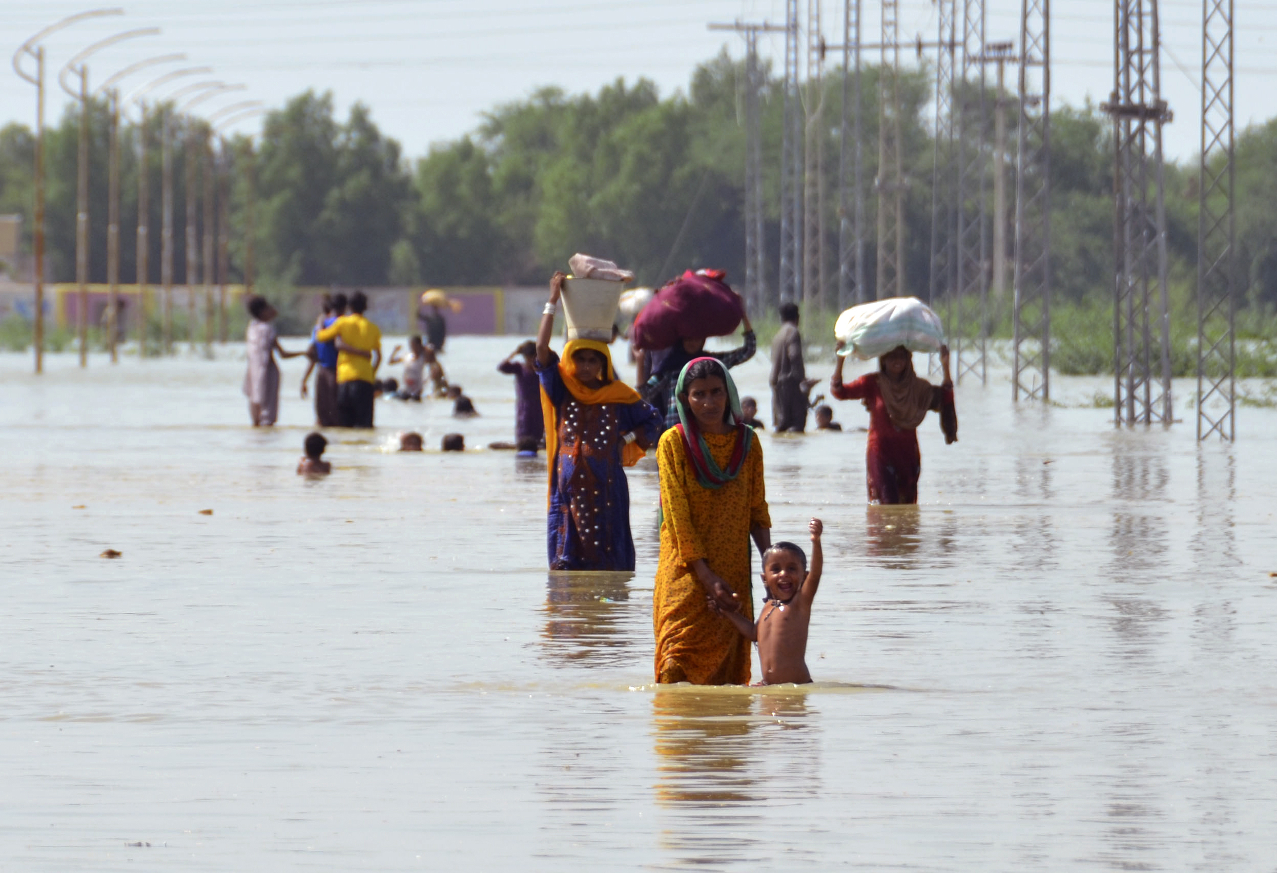 Displaced people carry belongings