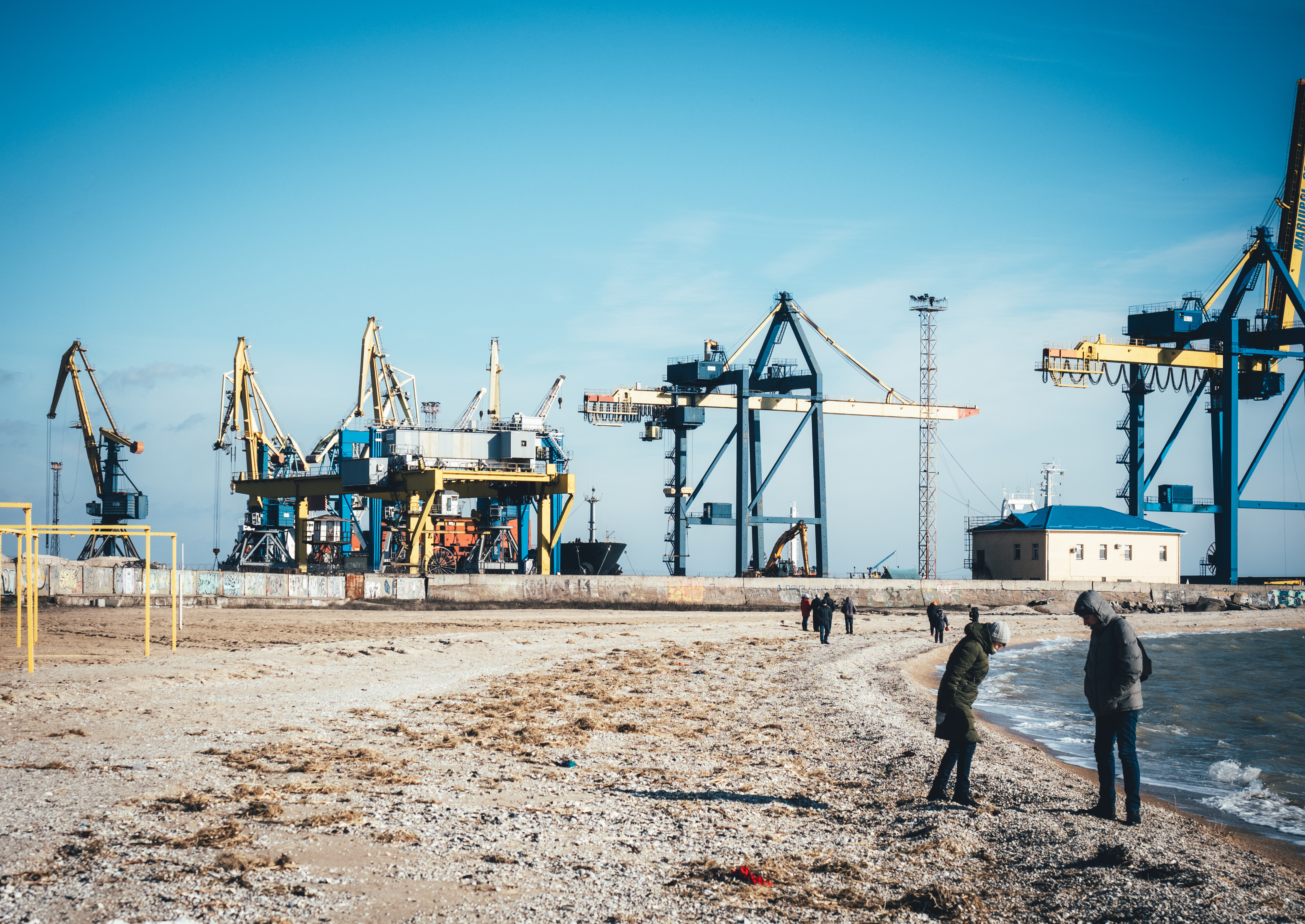 A photo of a beachfront with construction in the background.