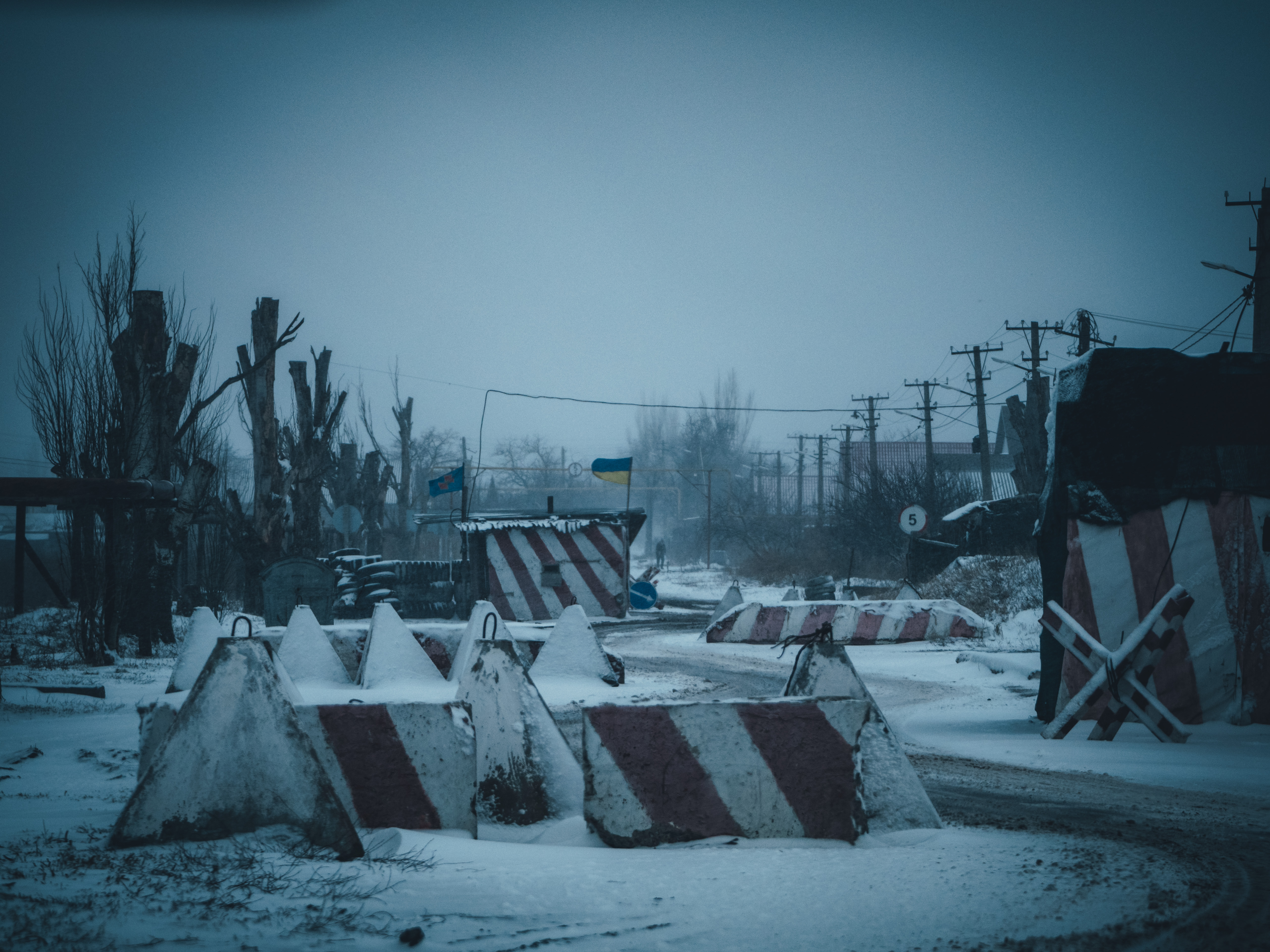 A photo of striped barriers in snow.