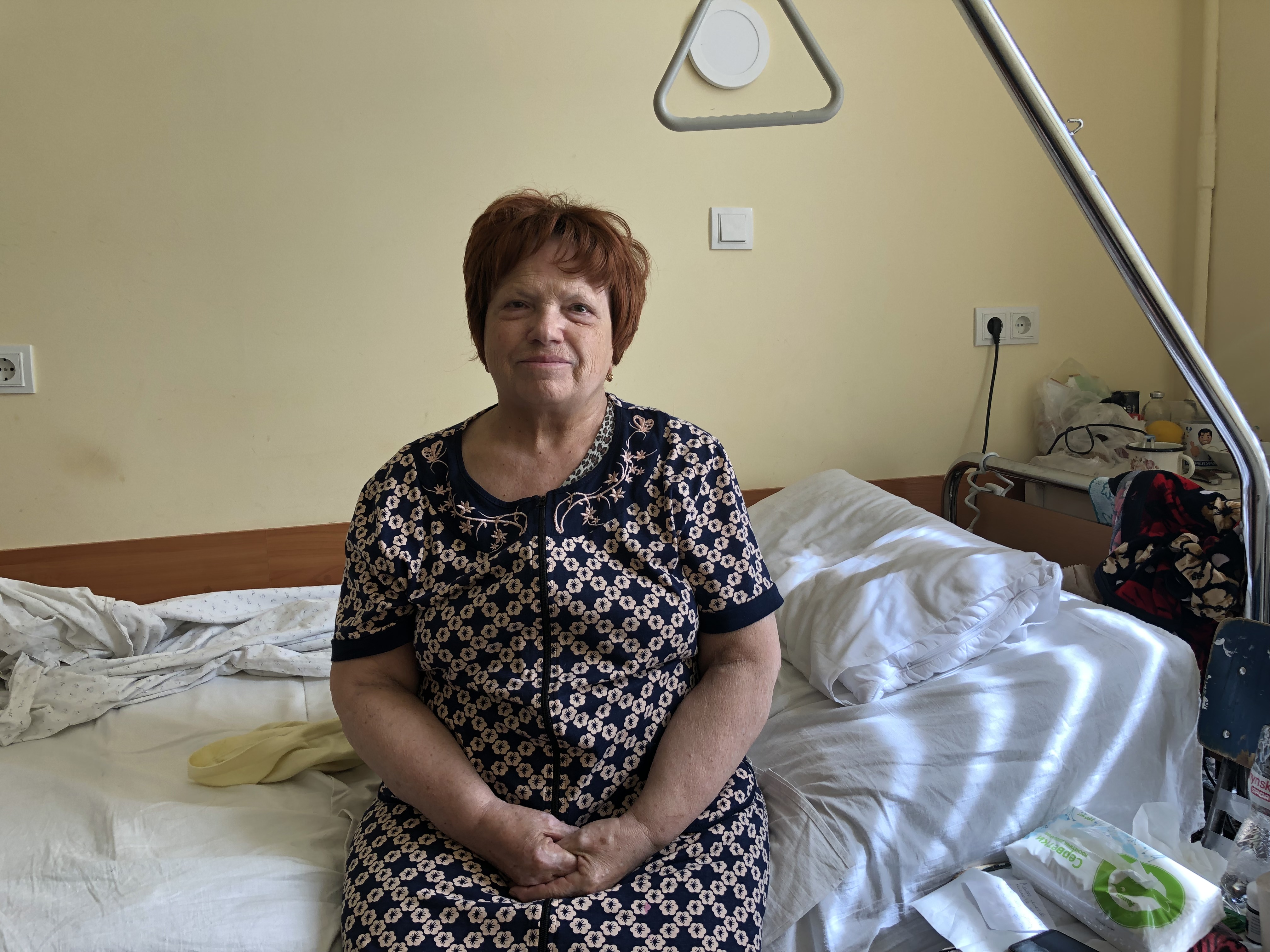 A photo of Halyna Sergeyevna sitting on a bed.