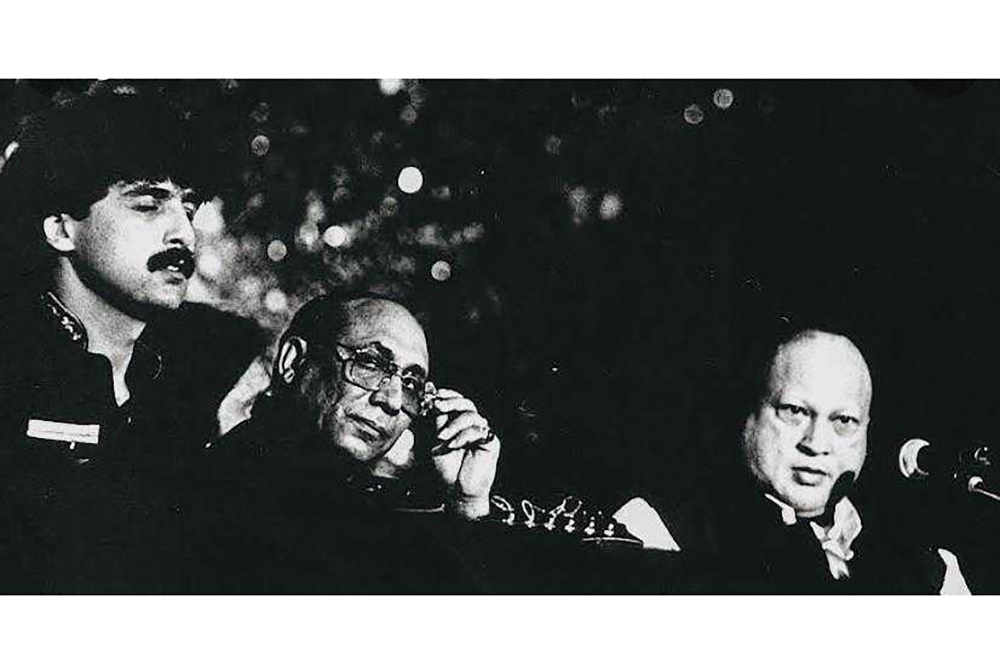 Salman Ahmad (far left) on stage with Nusrat Fateh Ali Khan (far right) performing at a fundraiser
