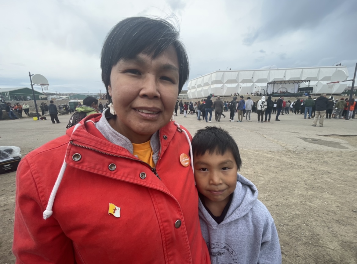 A photo of a person with a child next to them.