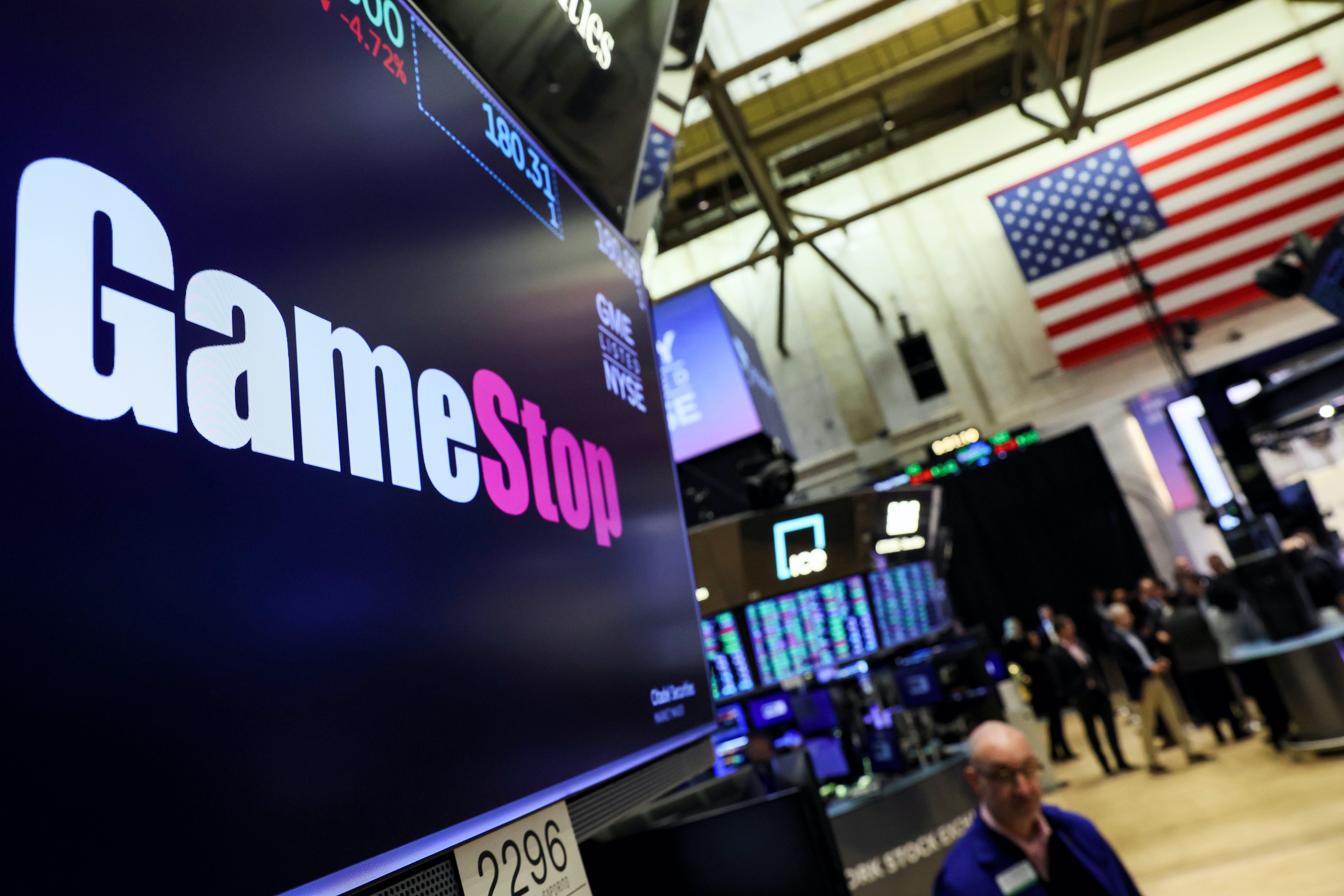 A screen displays the logo and trading information for GameStop on the floor of the New York Stock Exchange (NYSE) in New York City, U.S