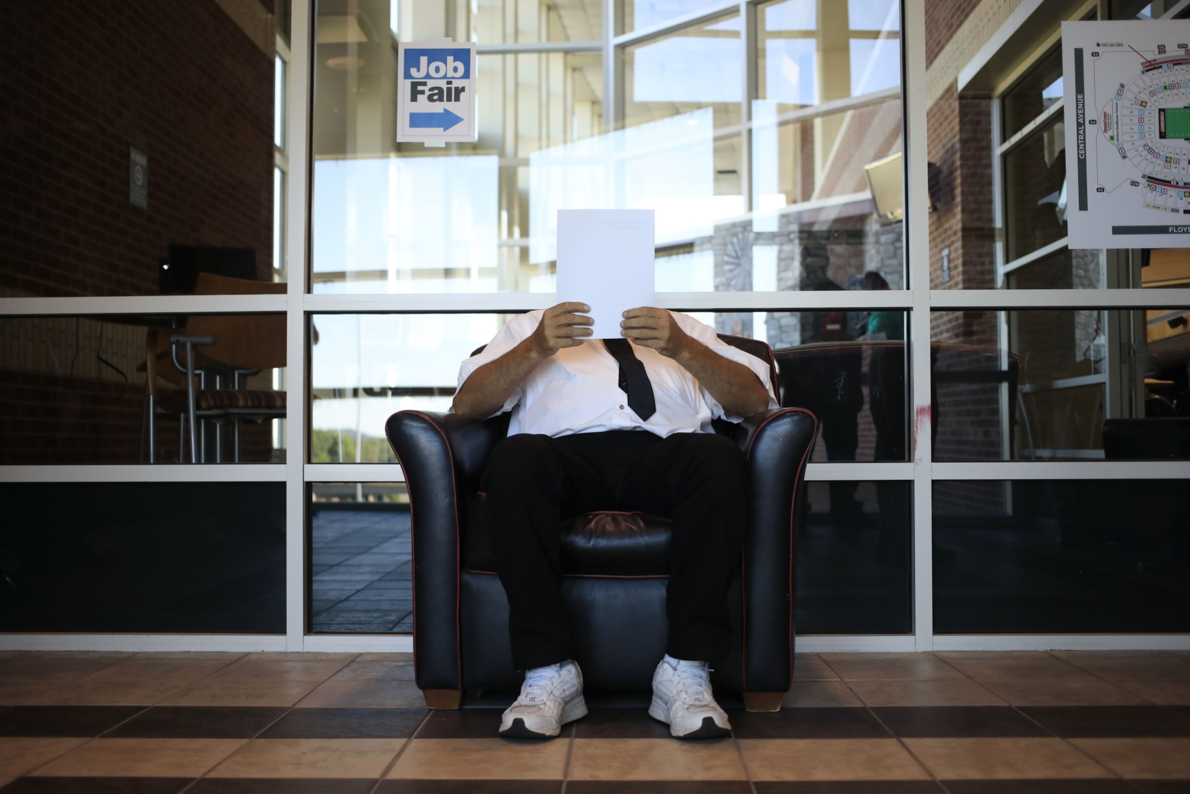 A job seeker reads paperwork during a Job News USA career fair in Louisville, Kentucky, U.S.