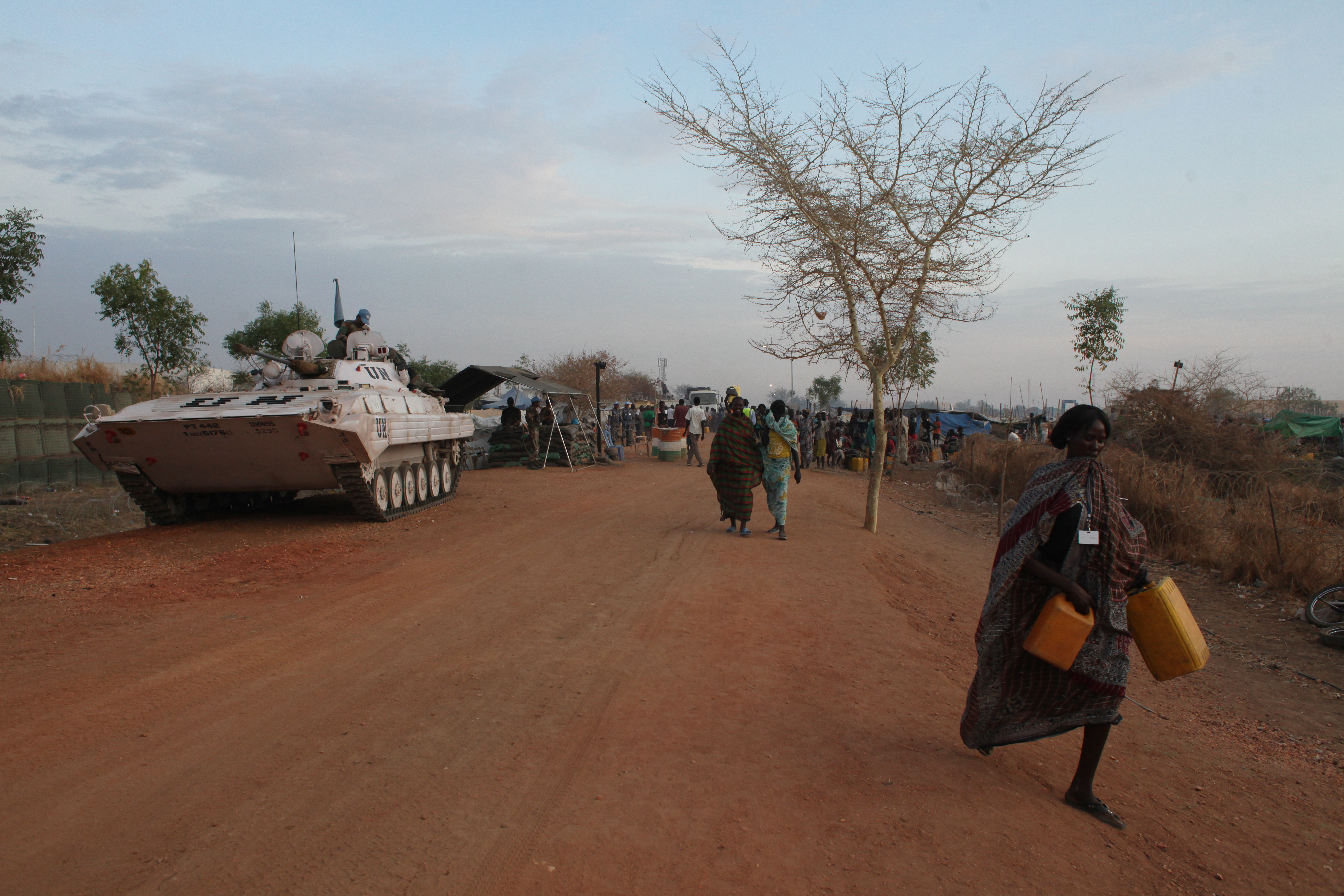 Women walk past a UN tank inside the inside de POC (protection of civilians site) in Malakal, South Sudan, on March 3rd, 2014