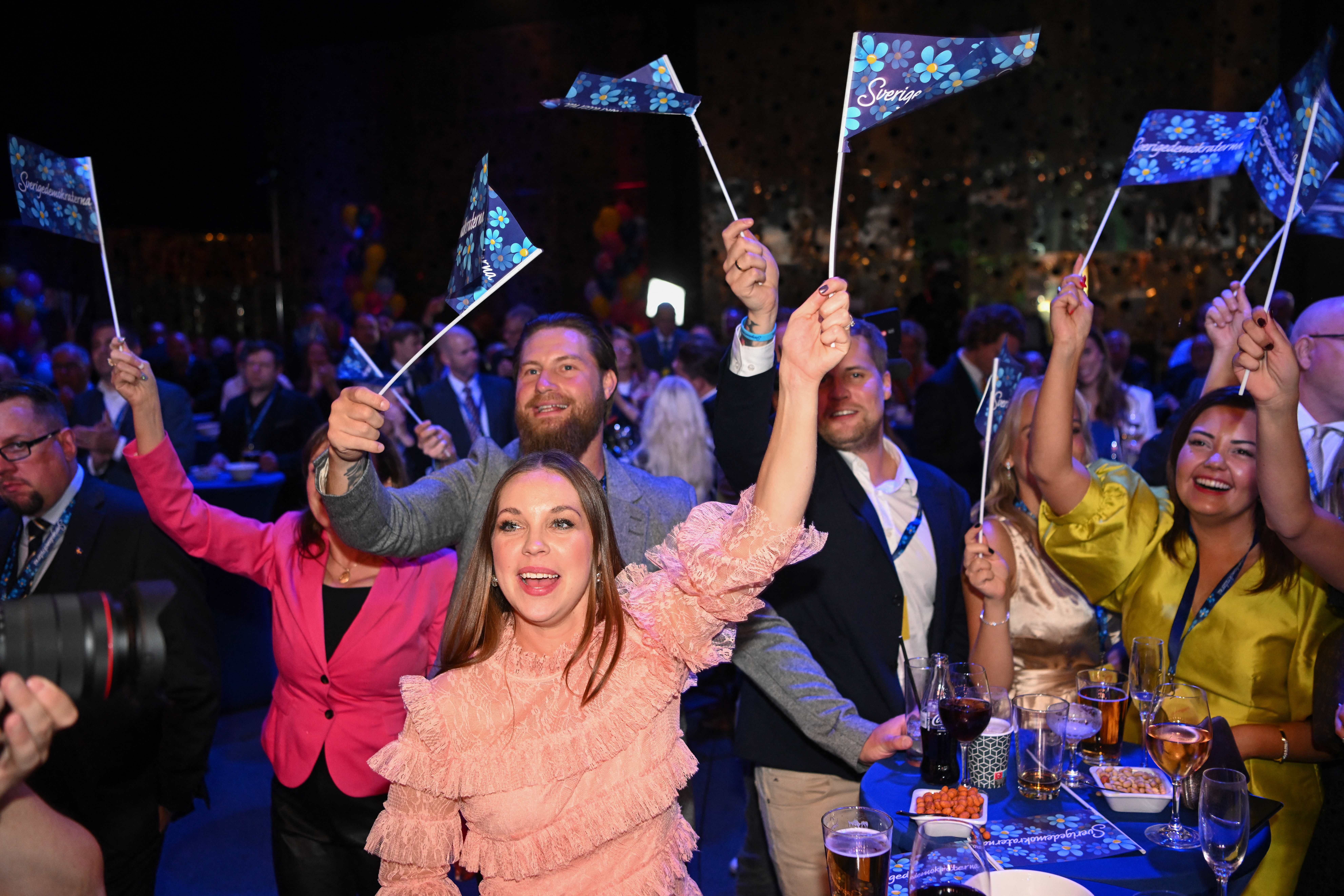 Supporters of the far right Sweden Democrats wave flags and celebrate their performance in Sunday's election