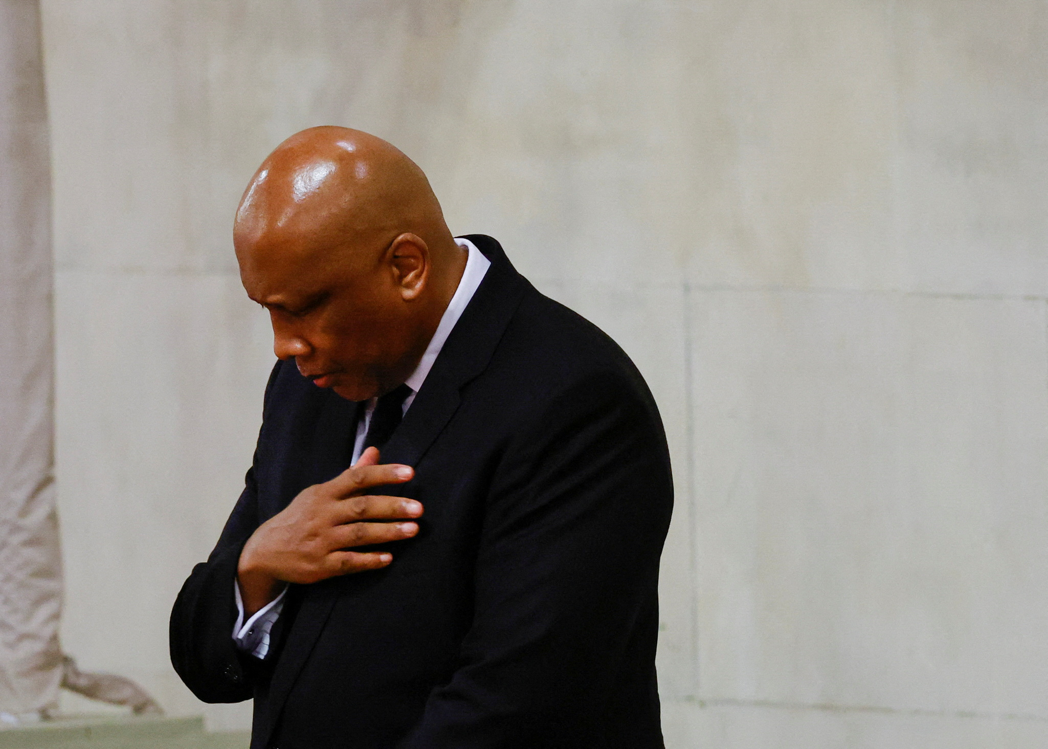 King Letsie III of Lesotho places his right hand on his heart and bows his head as he pays respects to Queen Elizabeth