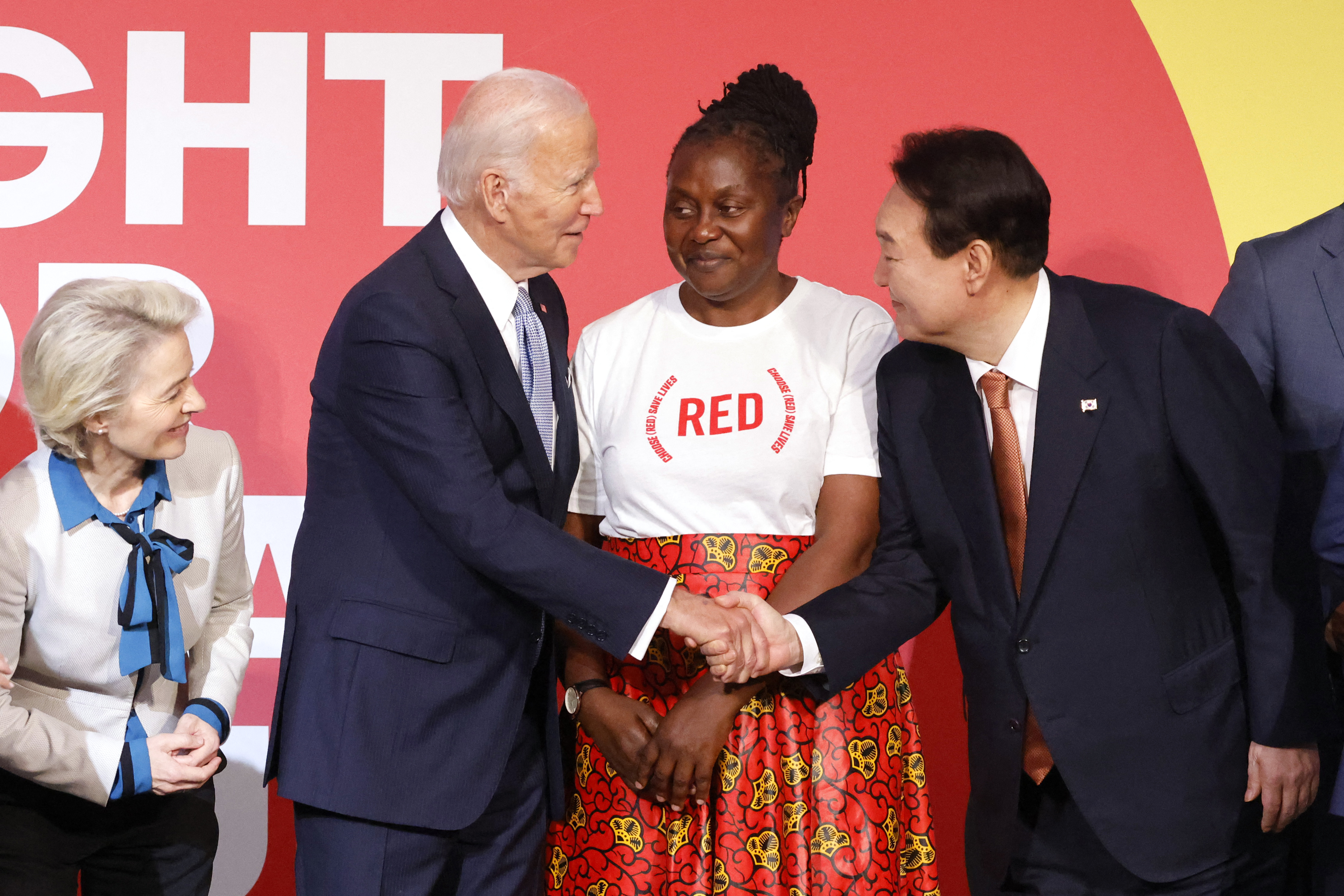 EU Commission President Ursula von der Leyen and Ambassador and AIDS activist Connie Mudenda look on as US President Joe Biden shakes hands with South Korean President Yoon Suk-yeol at the Global Fund donor conference