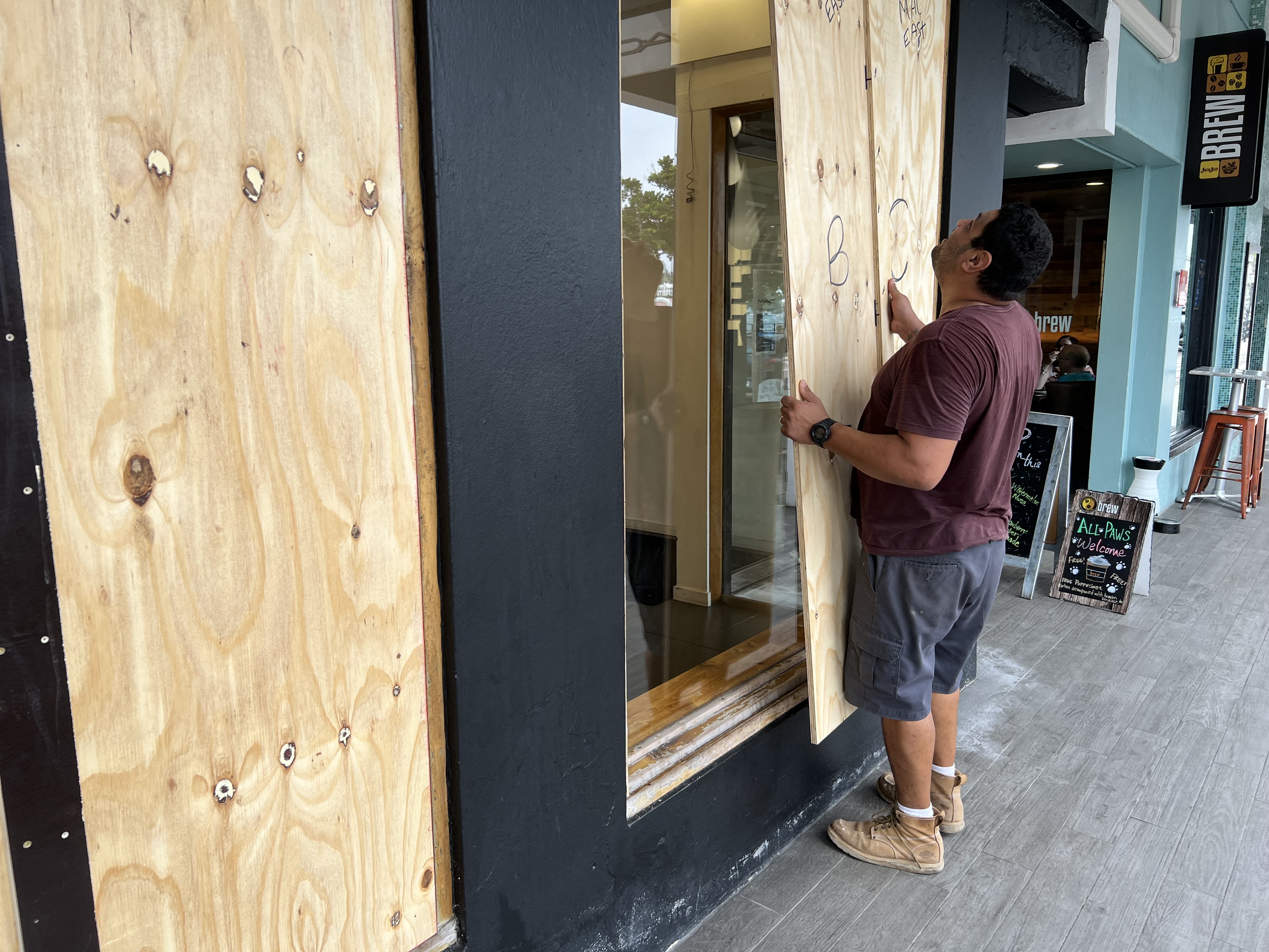 A man boards up a store in Hamilton, Bermuda