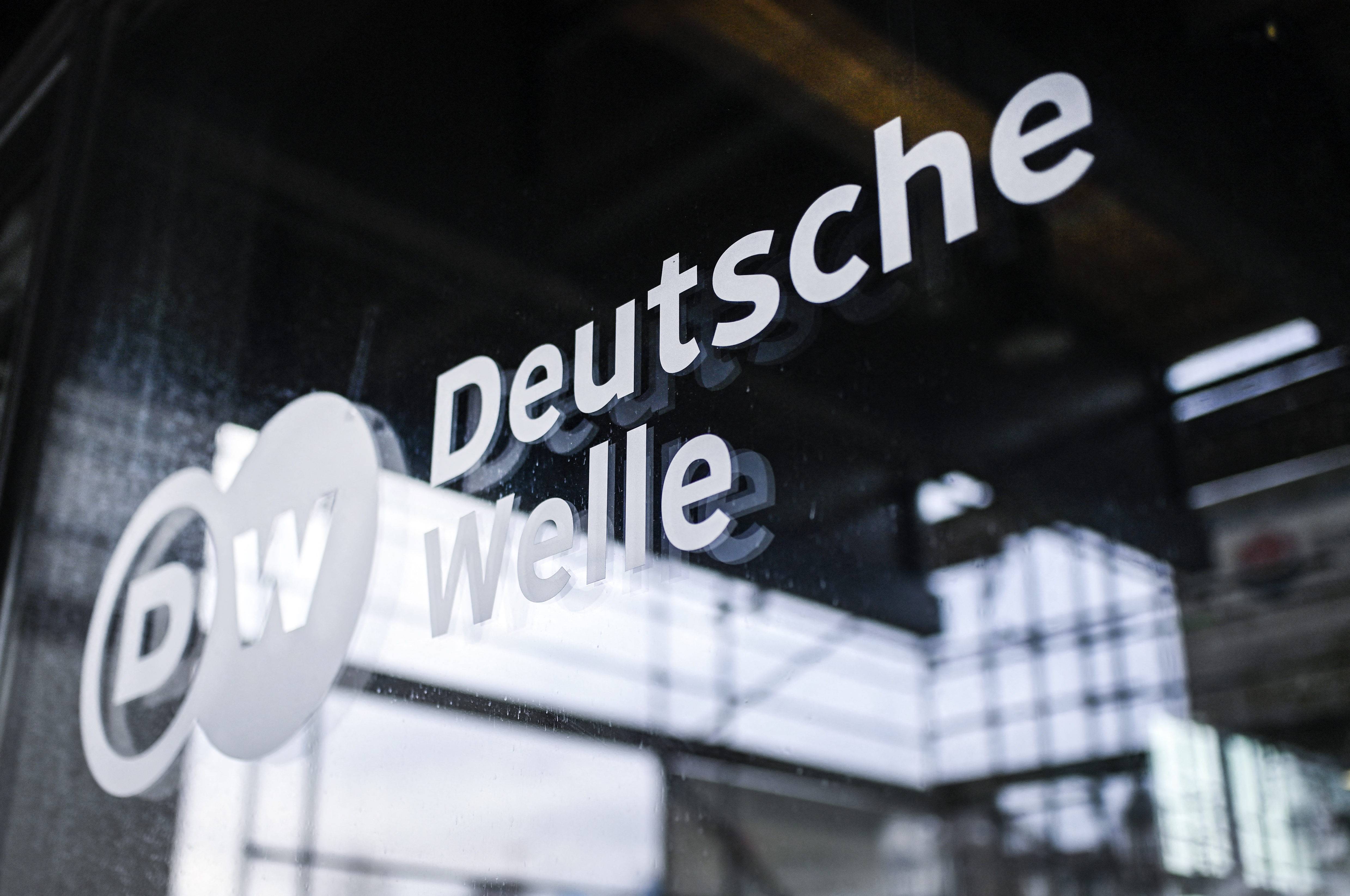 A picture shows the logo of German international broadcaster Deutsche Welle (DW) on a a glass at their head office in Bonn, western Germany, on February 8, 2022. - Russia closed the Moscow bureau of German broadcaster Deutsche Welle and revoking staff accreditations in Russia on February 3, in response to Berlin's ban on the German-language channel of Russian state TV network RT. (Photo by Ina FASSBENDER / AFP)