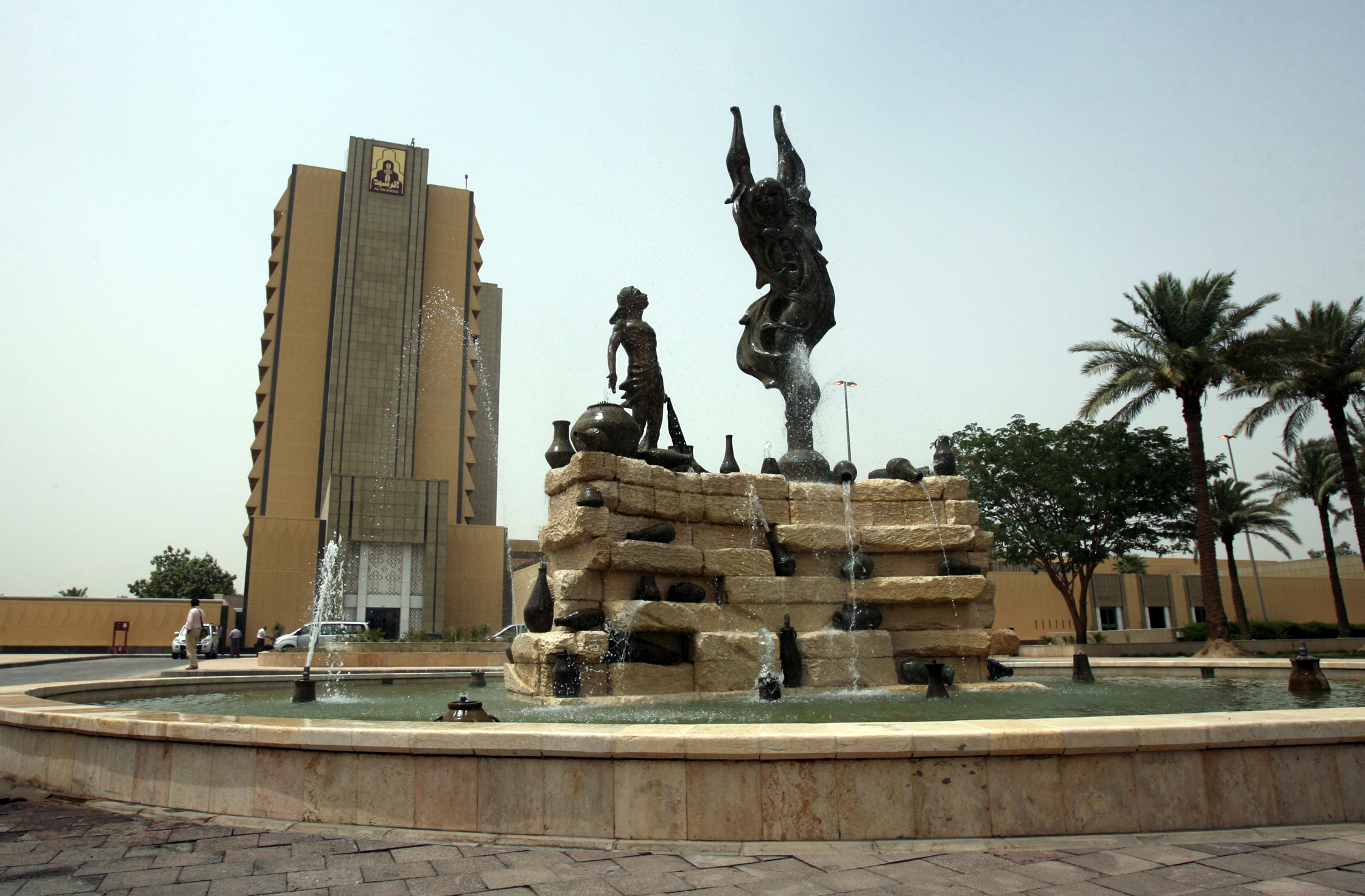 A photo of a water fountain in front of a building.
