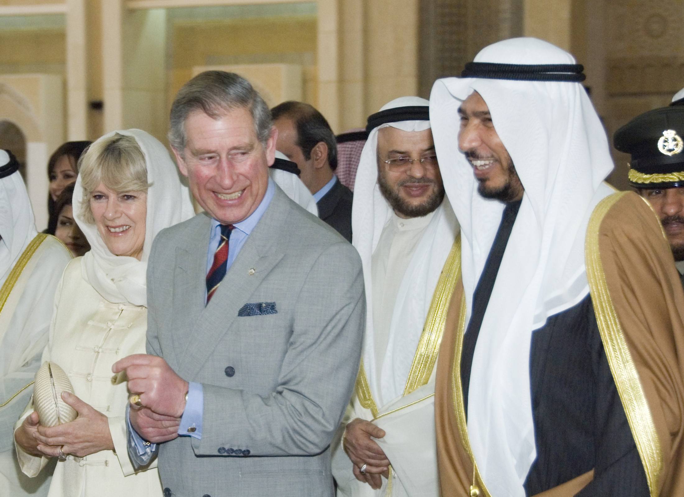 Prince Charles and his wife, Duchess of Cornwall, Camilla, walk with Kuwait Minister of Awkaf