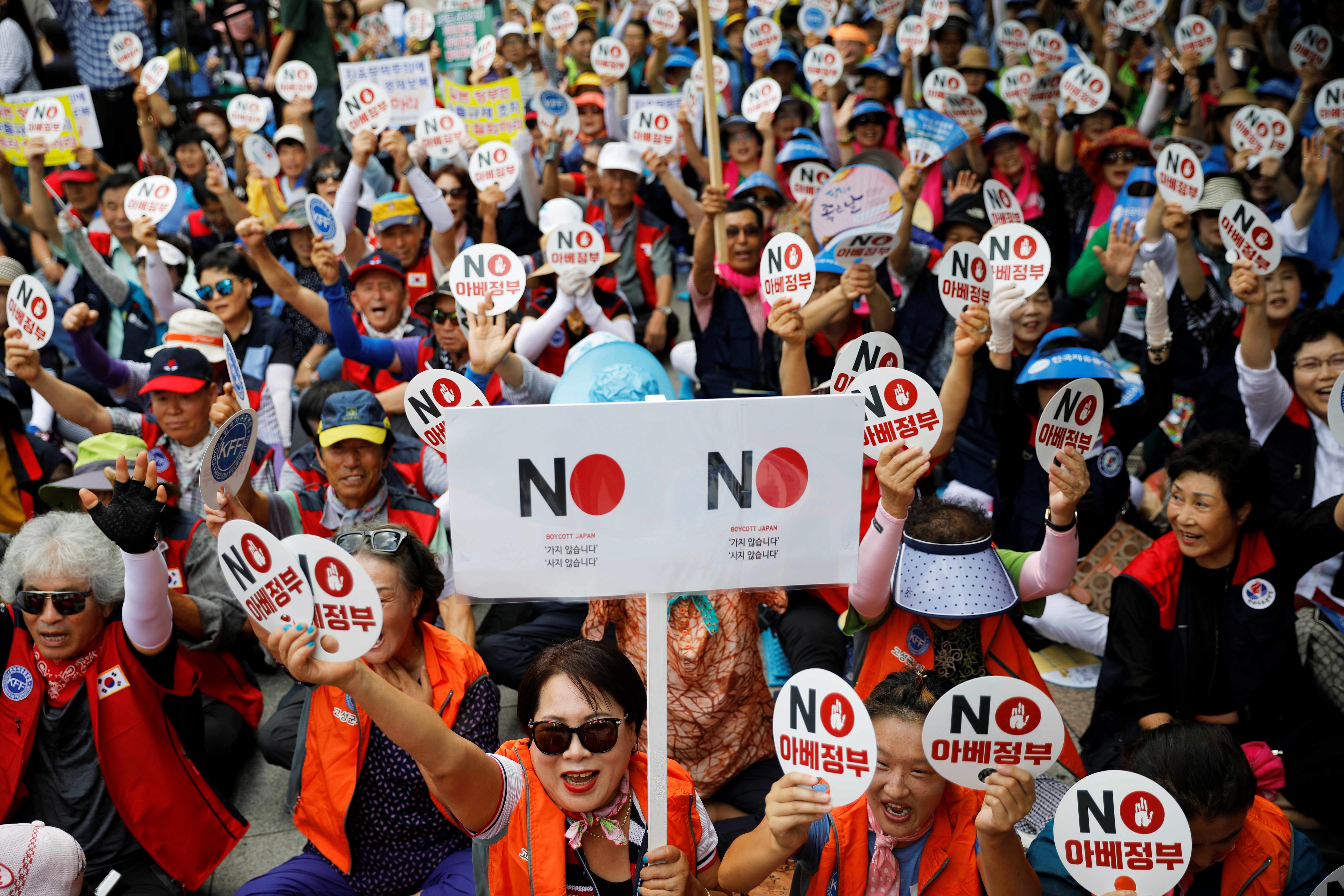 Members of a conservative civic group chant slogans during an anti-Japan protest in Seoul, South Korea, August 13, 2019.