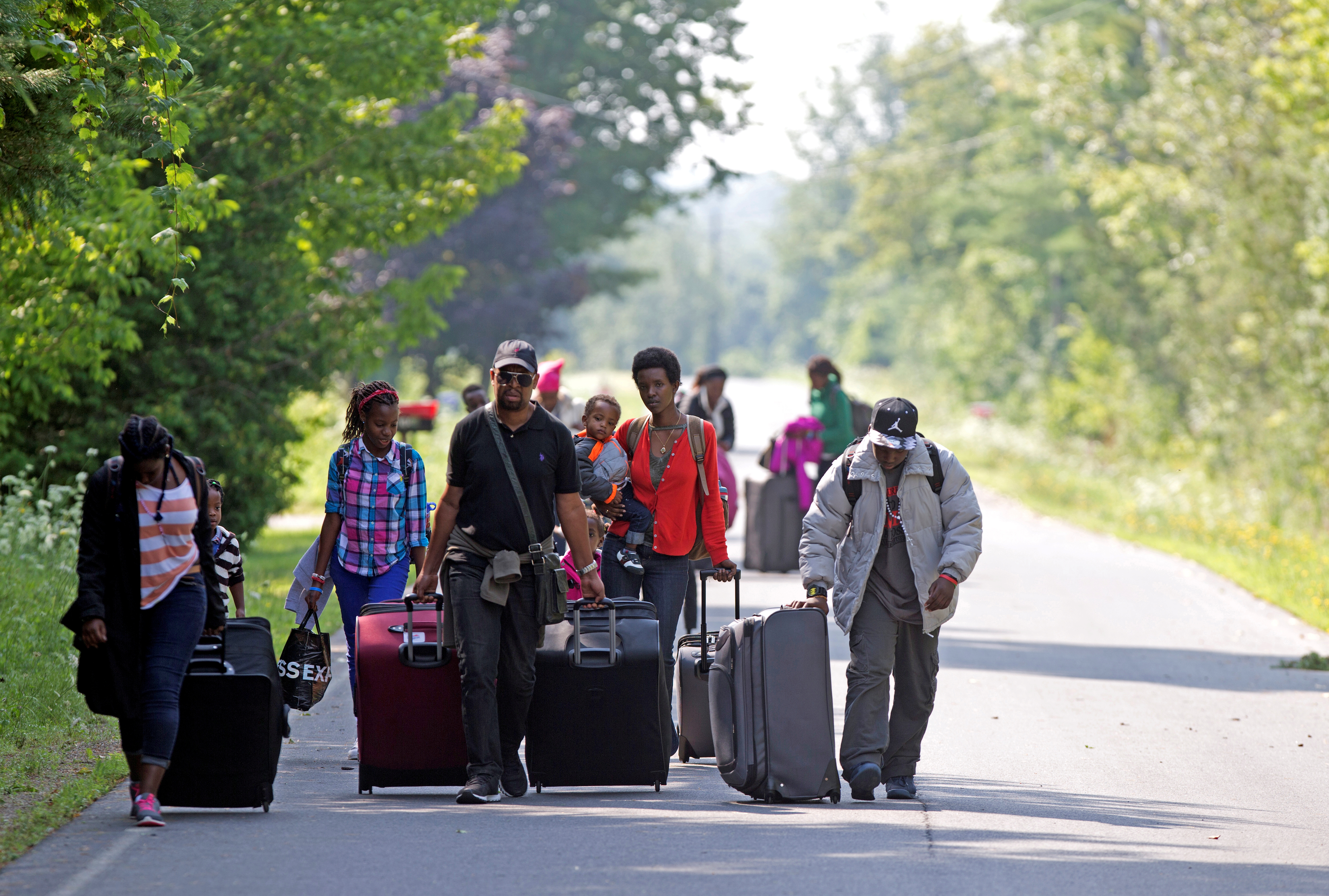 Families walk to Canada along Roxham Road, at the US border