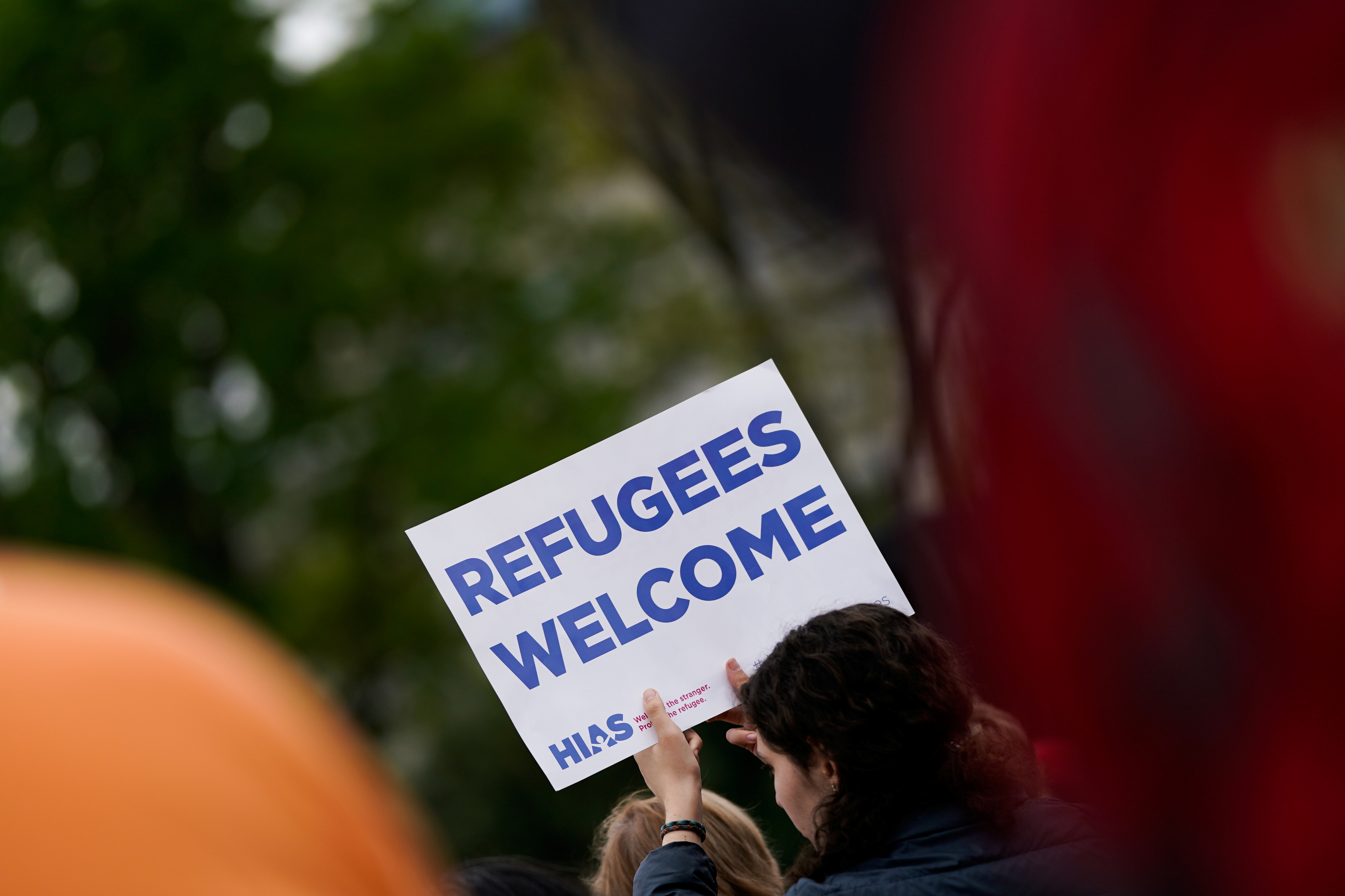People in support of rights for asylum seekers rally at the US Supreme Court in Washington, DC.