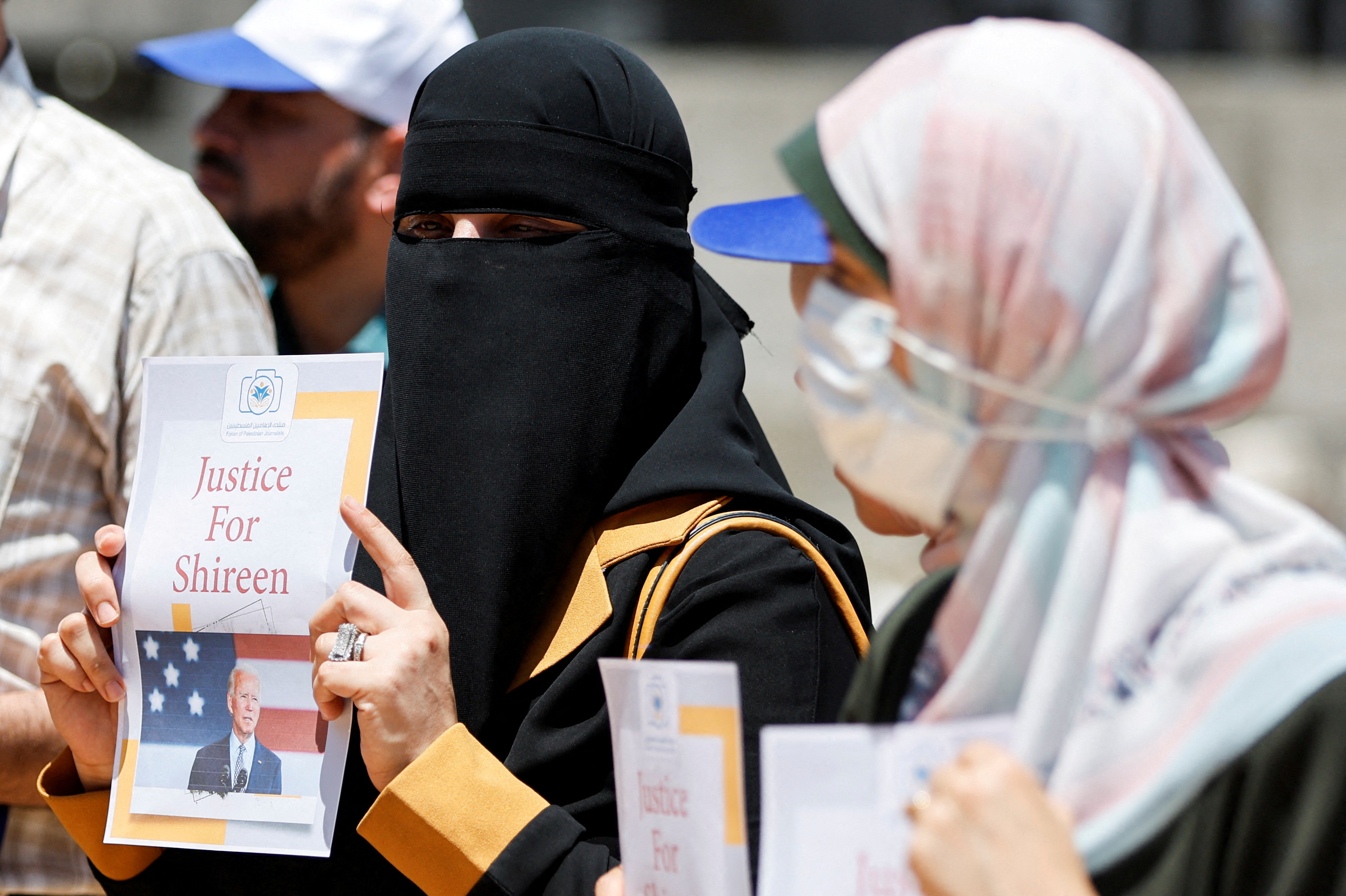 Palestinians attend a protest demanding U.S President Joe Biden to achieve justice for Al Jazeera journalist Shireen Abu Akleh, who was killed during an Israeli raid in Jenin, in Gaza City July 13, 2022.