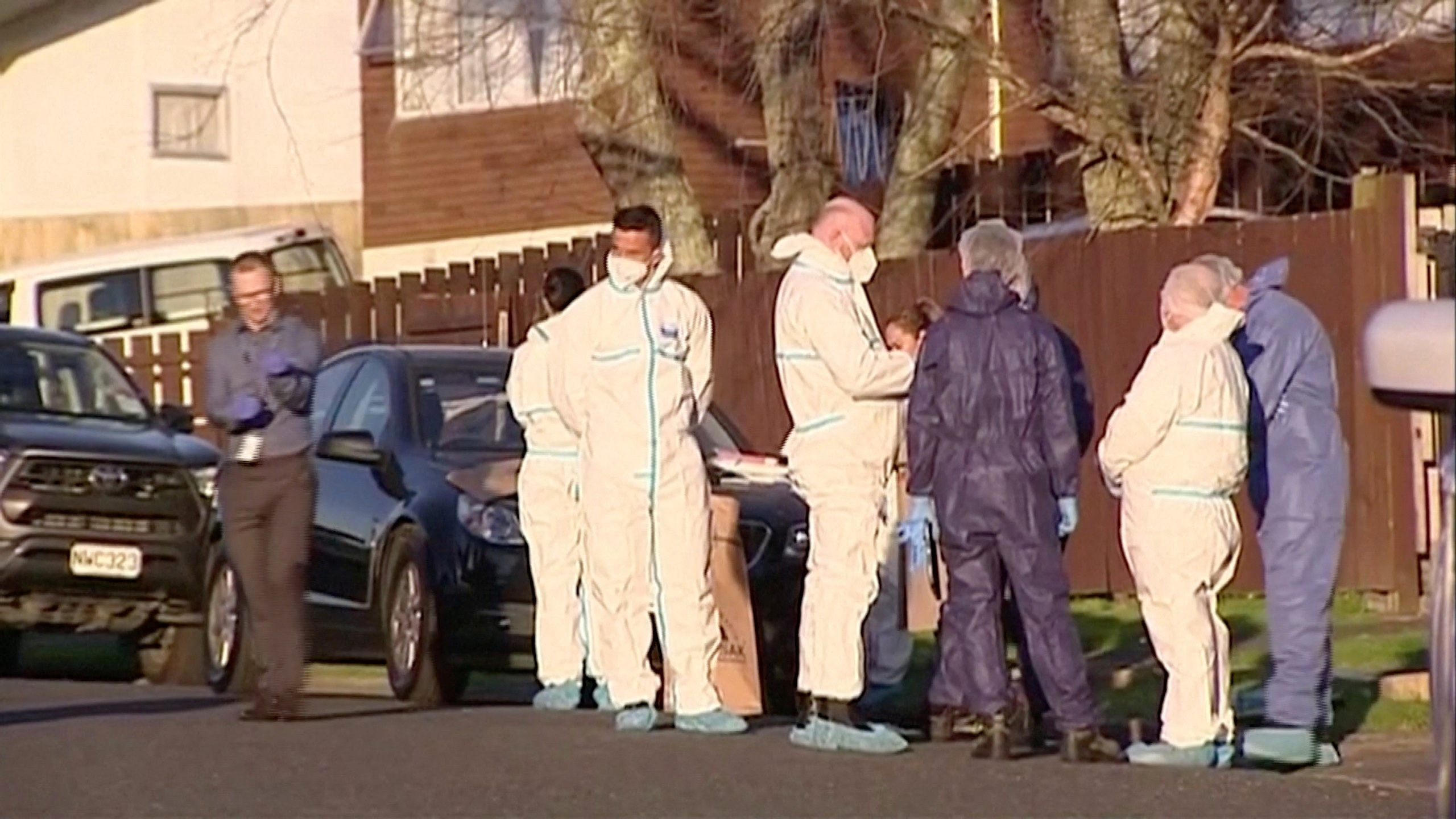 Police and forensic investigators gather at the scene where suitcases with the remains of two children were found, after a family, who are not connected to the deaths, bought them at an online auction for an unclaimed locker, in Auckland, New Zealand, August 11, 2022.