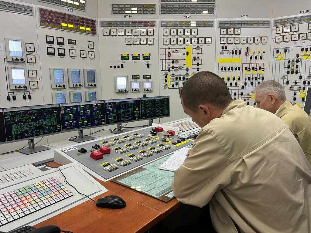 Two men work at a control panel at the Zaporizhzhia Nuclear Power Plant in Ukraine.