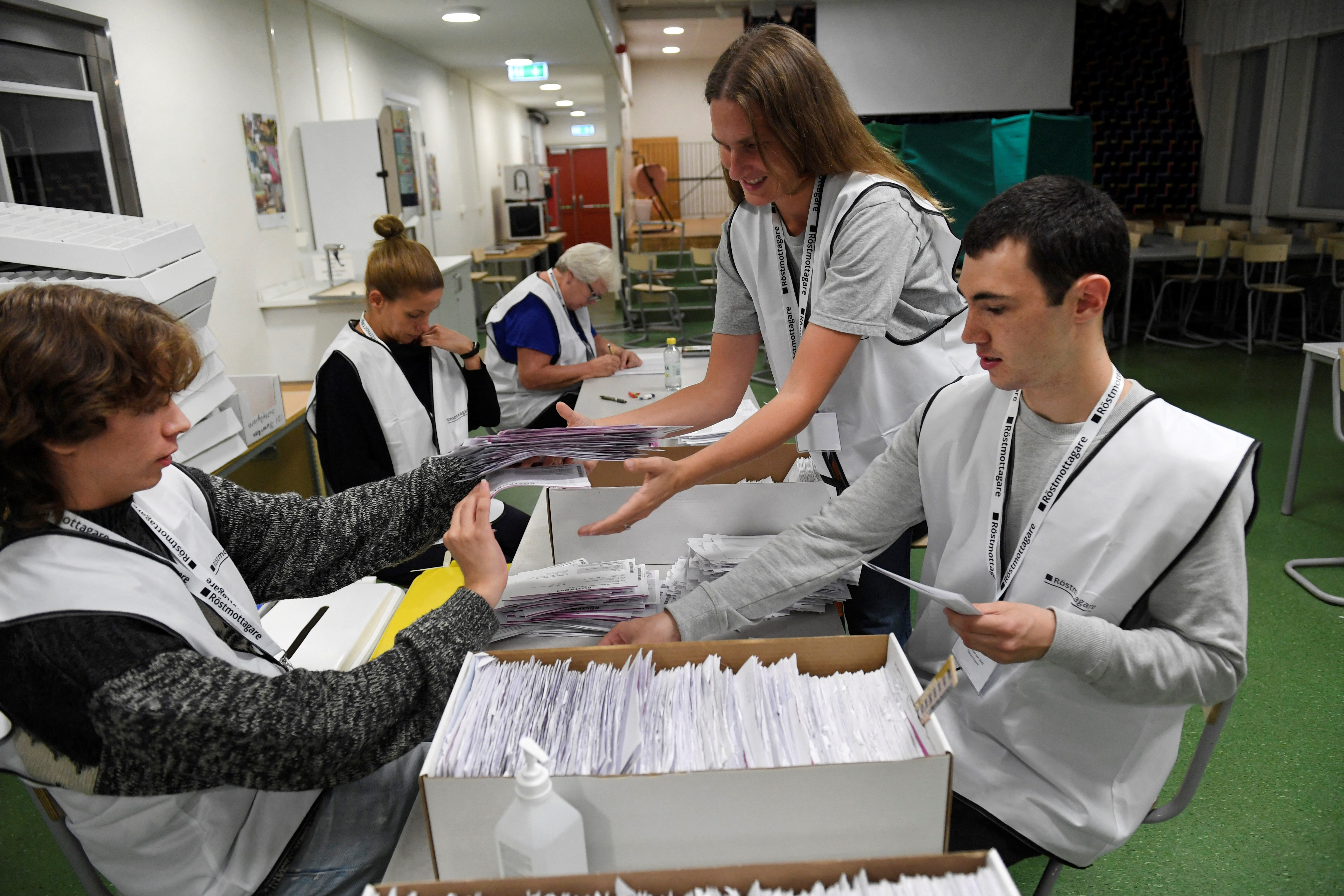 Vote counters count casted votes at a polling station near Stockholm.