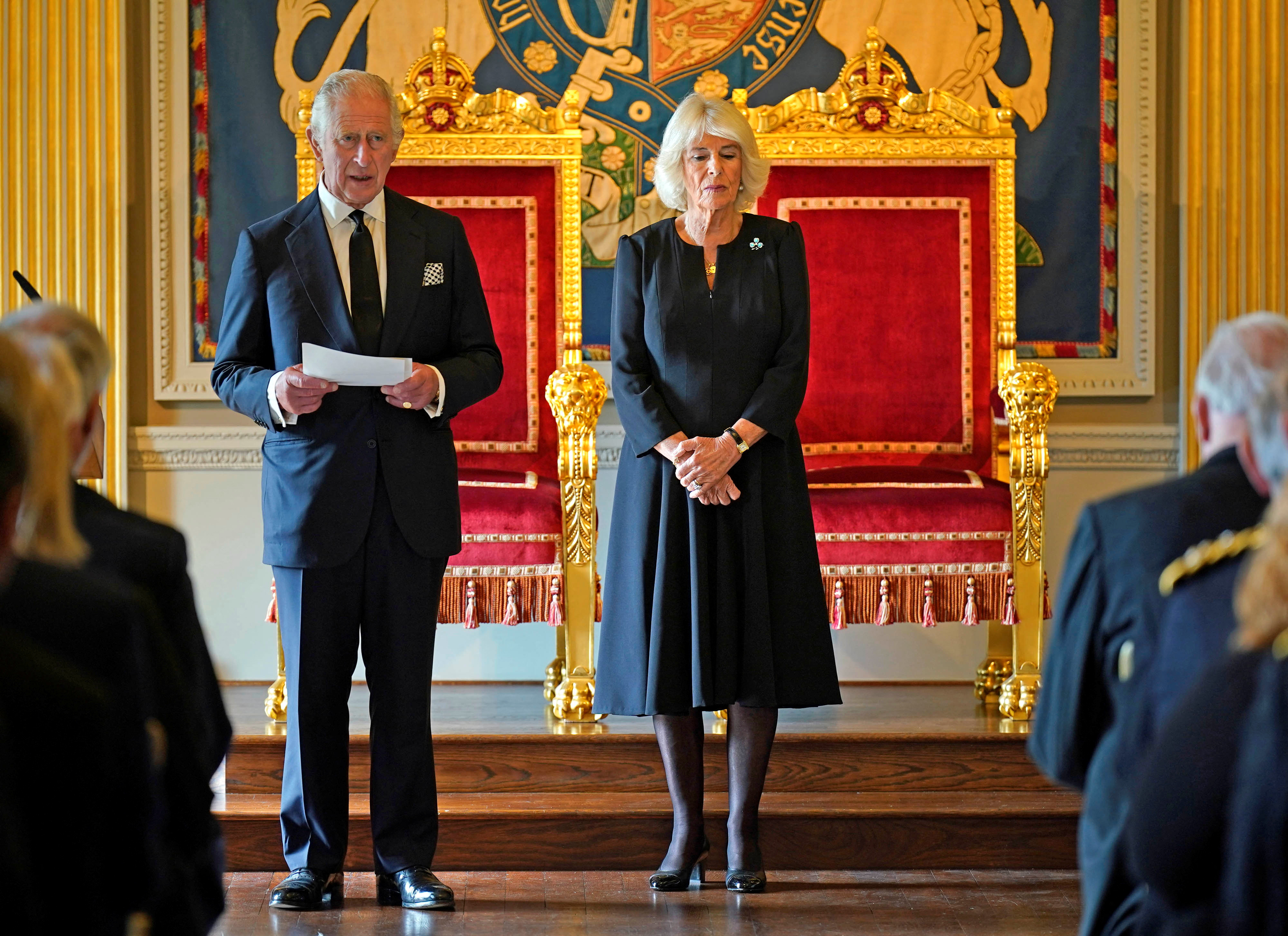 King Charles III, with the Queen Consort, speaking