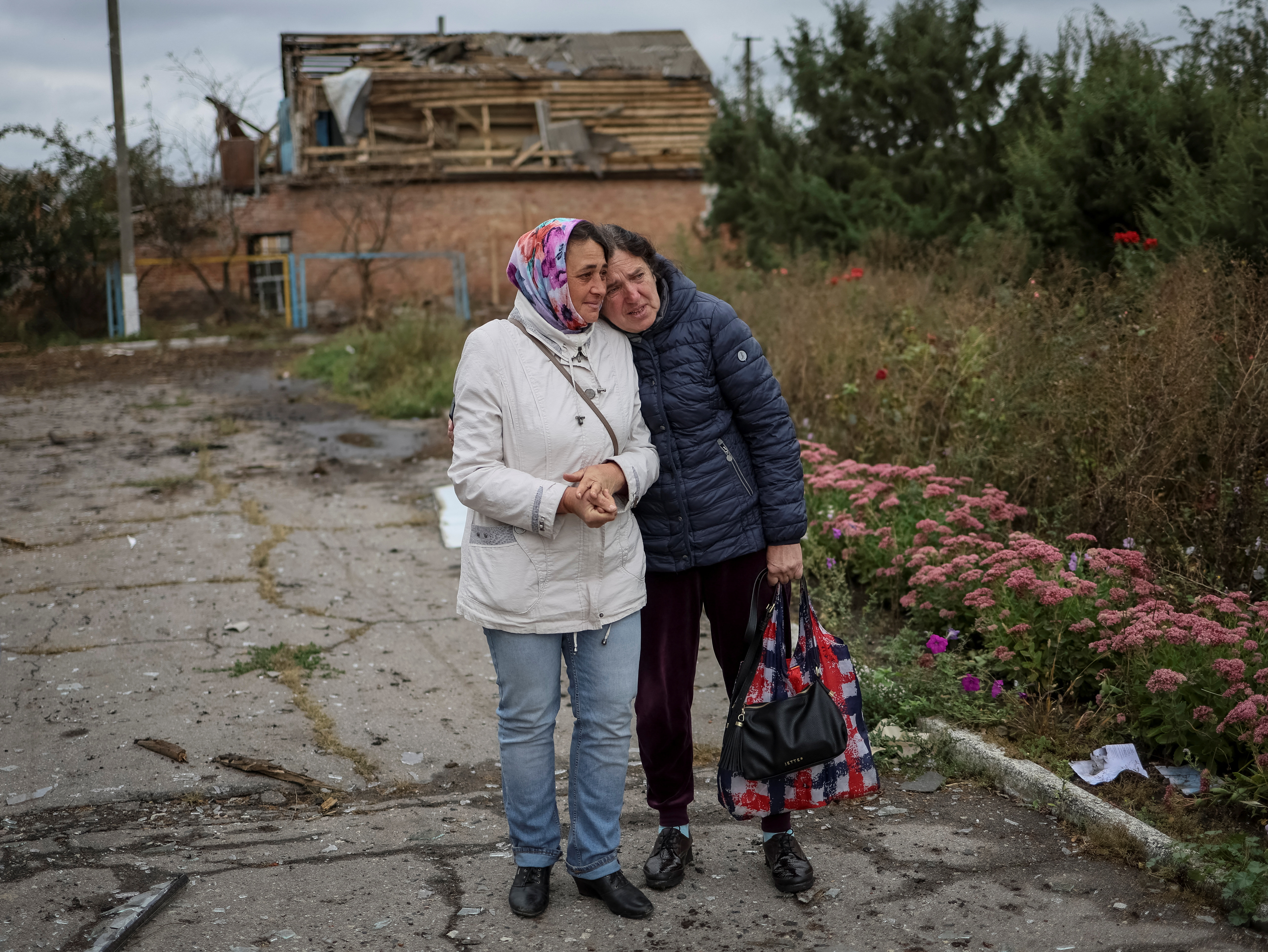Two Ukrainian women stand in village of Verbivka in Kharkiv region