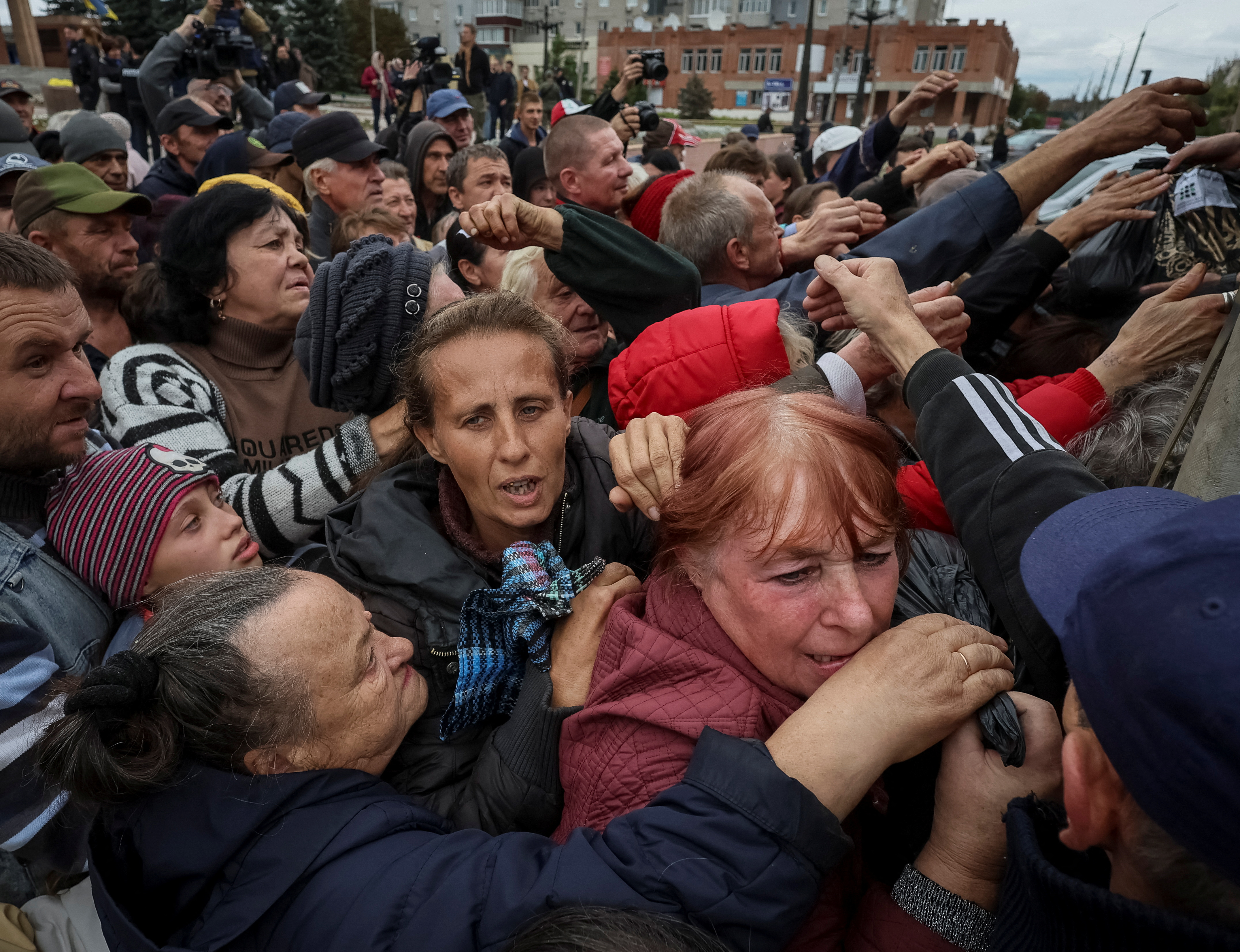 Residents in the town of Balakliia jostle for essential supplies following the town's liberation from Russian occupation